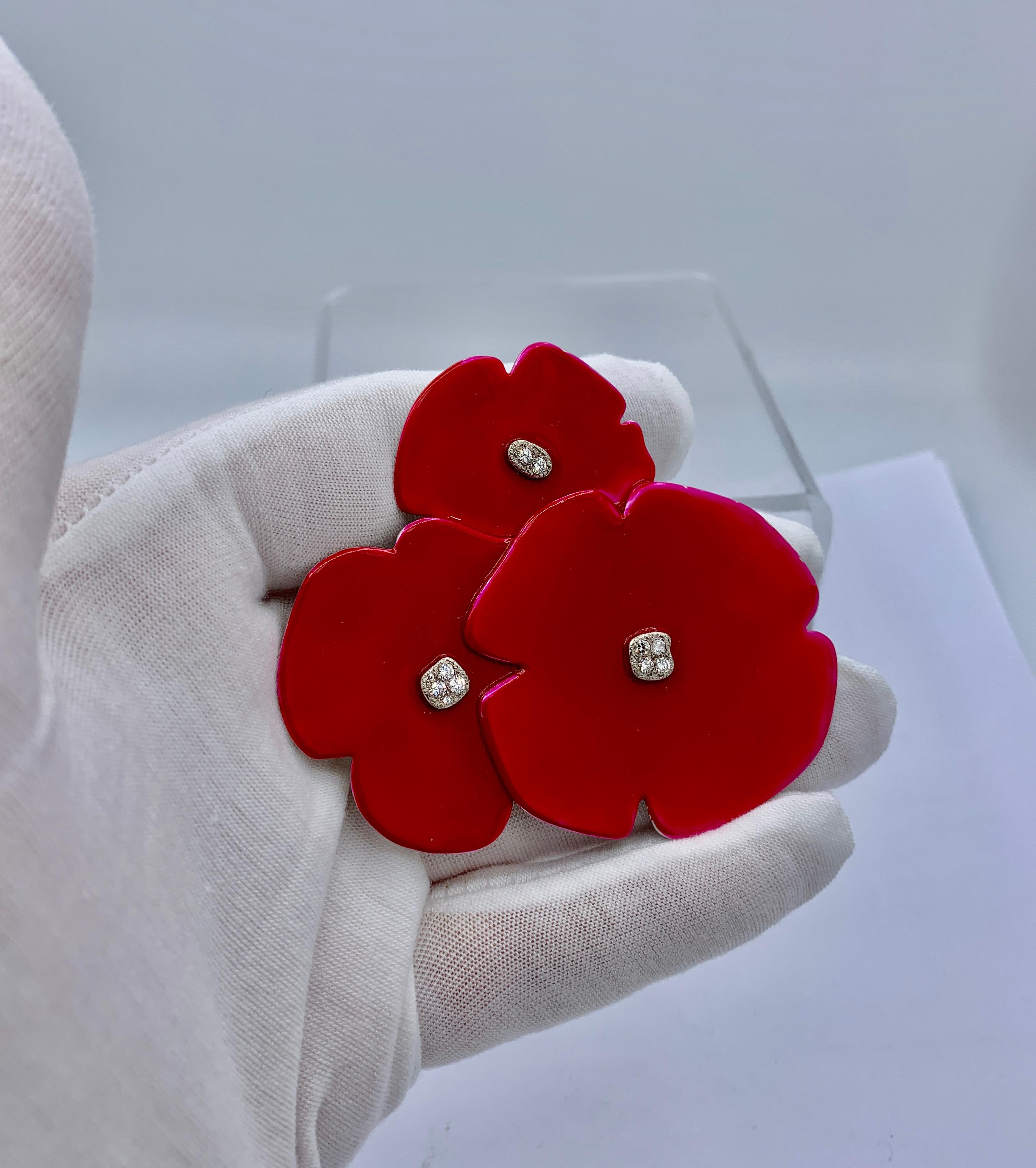 This is a fabulous large dramatic pendant or brooch of Poppy Flowers in red lacquer set with Diamonds in 14 Karat White Gold by Helen Blythe-Hart.  The poppies are a spectacular piece of original jewelry art sculpture by famed artist Helen