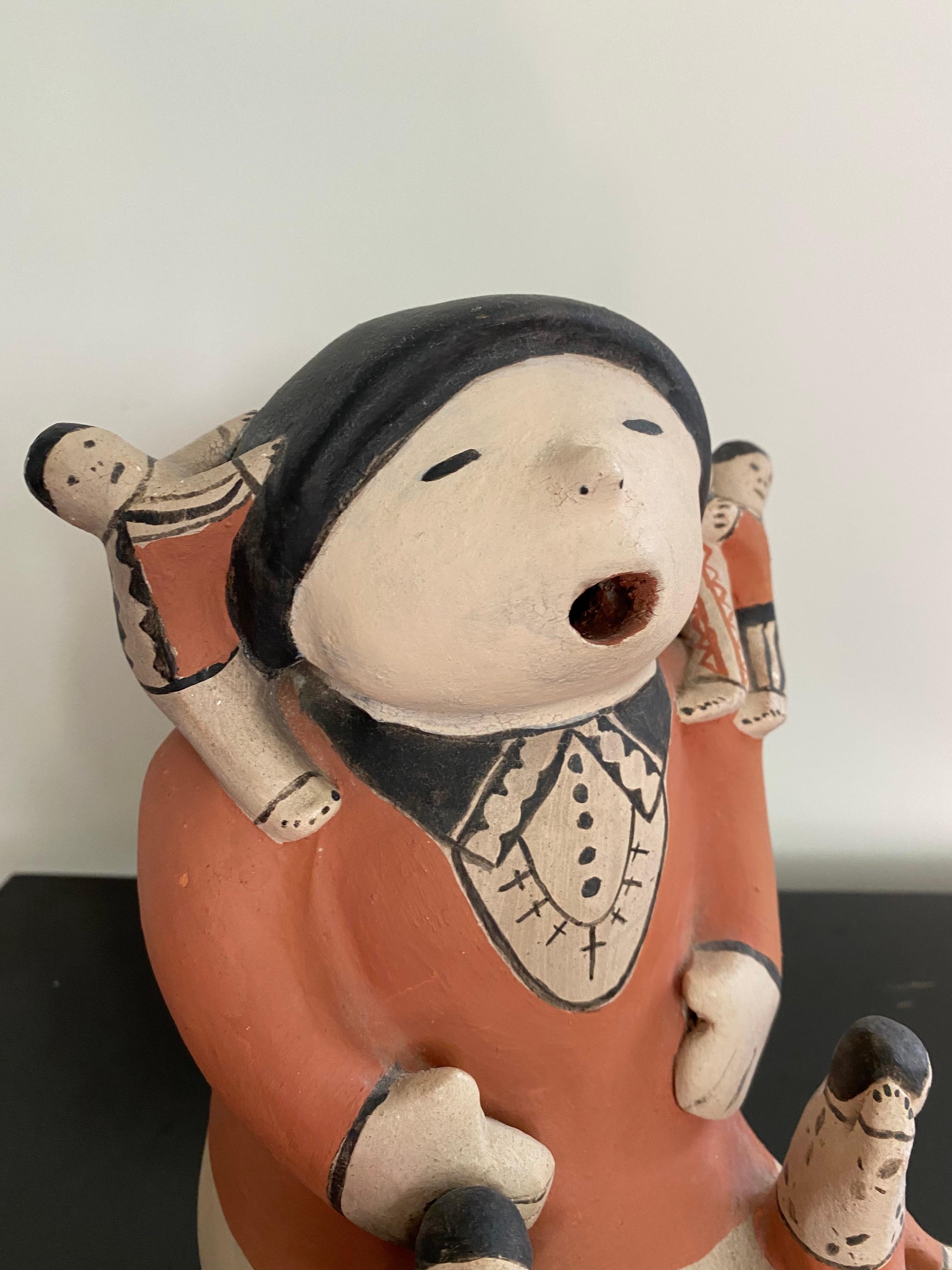 Helen Cordero story tellers ceramic figure. The famous Grande Dame of Story Teller Potters. This piece was among her last creations, 1989. Singing Mother Motif, Clay is a living substance! Figurines are like living being in Pueblo lore, Storytellers