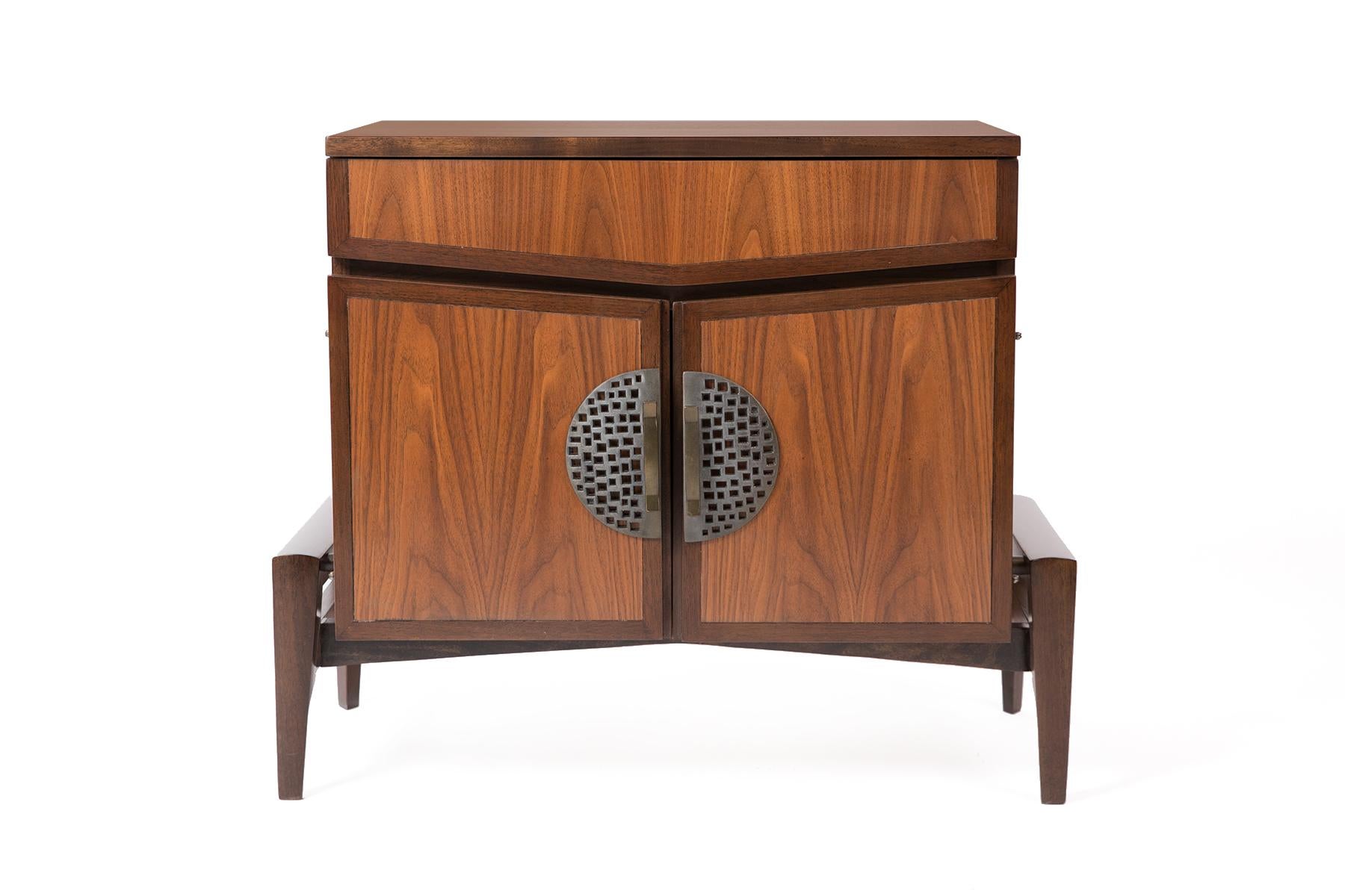 Pair of newly finished walnut nightstands by Helen Hobey for Baker. These examples feature formed bronze pulls, sculptural forms and plenty of interior storage. Price listed is for the pair.