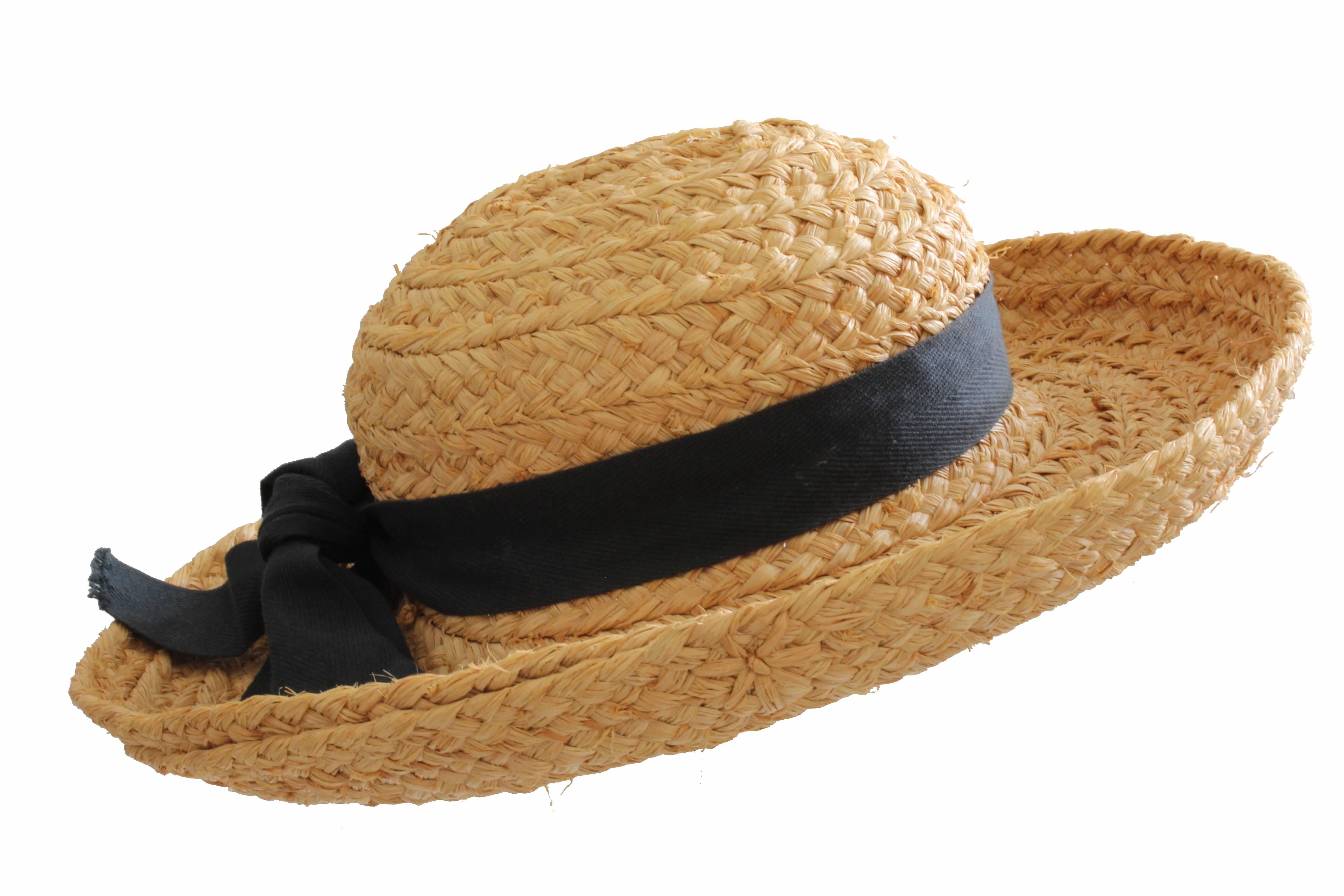 This classic straw hat was handmade in Madagascar for Helen Kaminski of Australia, the brand known for their intricate woven hat designs and now owned by the Bollman Hat Company.  Made in the 1990s, this hat features hand plaited wide braid