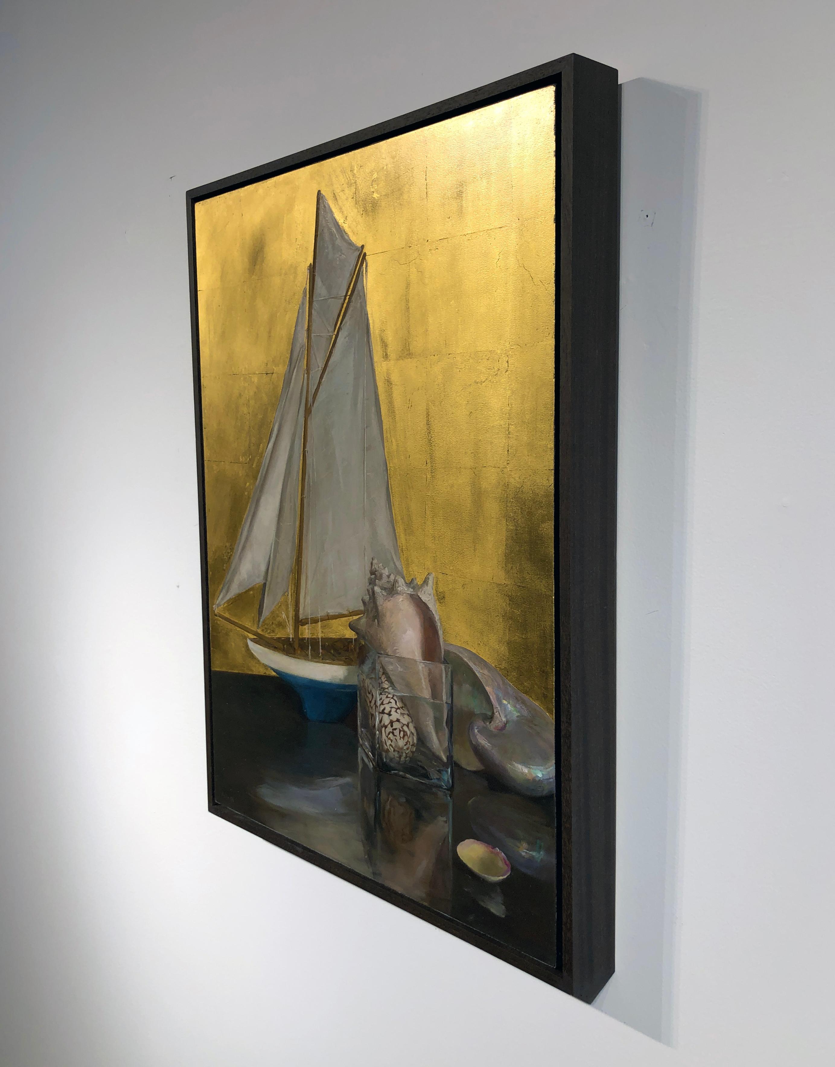Gorgeous gold leaf warms the background of this nautically themed still life.  A model sailboat and a collection of seashells are arranged atop a reflective table.  This masterful painting by Helen Oh evokes warm summer days and walks across the