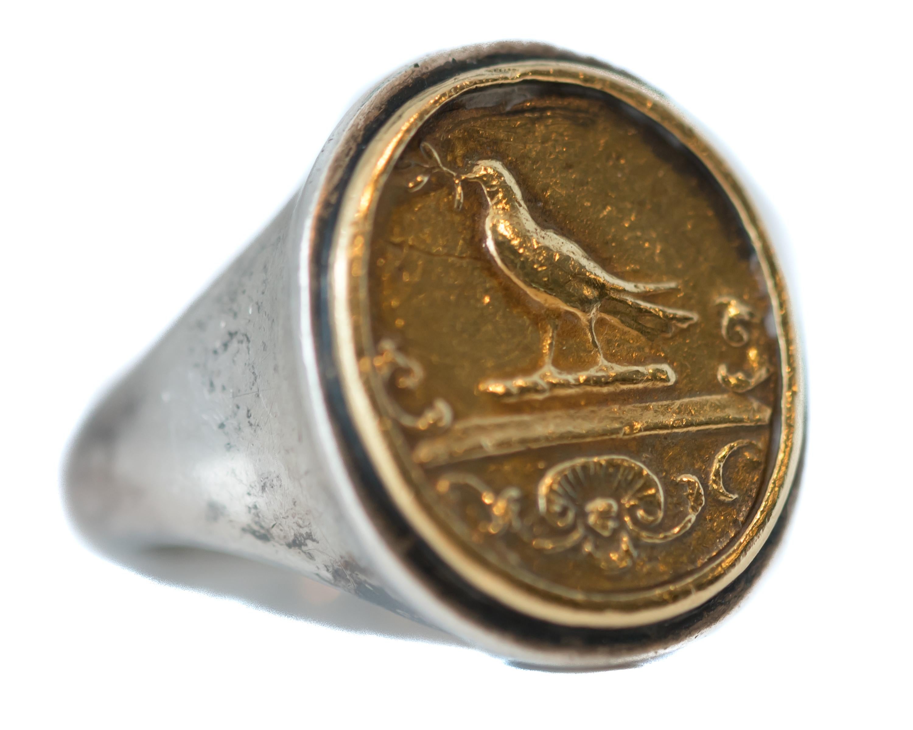 1950s Retro Helen Woodhull Bird Intaglio Ring - 22 Karat Yellow Gold, Sterling Silver

Features:
22 karat Yellow Gold and Sterling Silver Intaglio Ring
Bird motif in a gold oval framed by sterling silver
The ring face measures 18.5 x 16.5