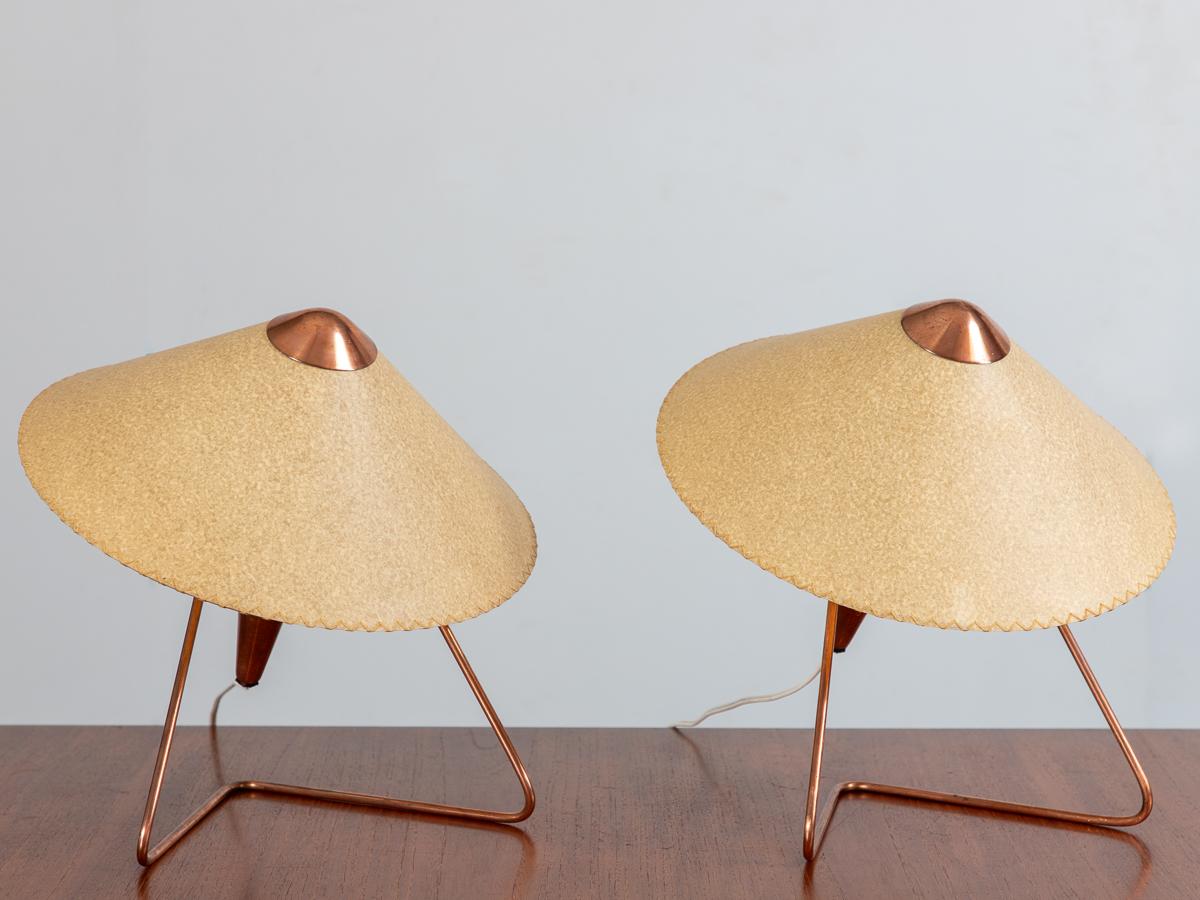 Pair of modernist lamps with copper finish, designed by Helena Frantova for Okolo. Torch style lamps, topped with a conical fiberglass shade. A versatile design that can be used as a table lamp or as a wall sconce. Made in two sizes, this is the