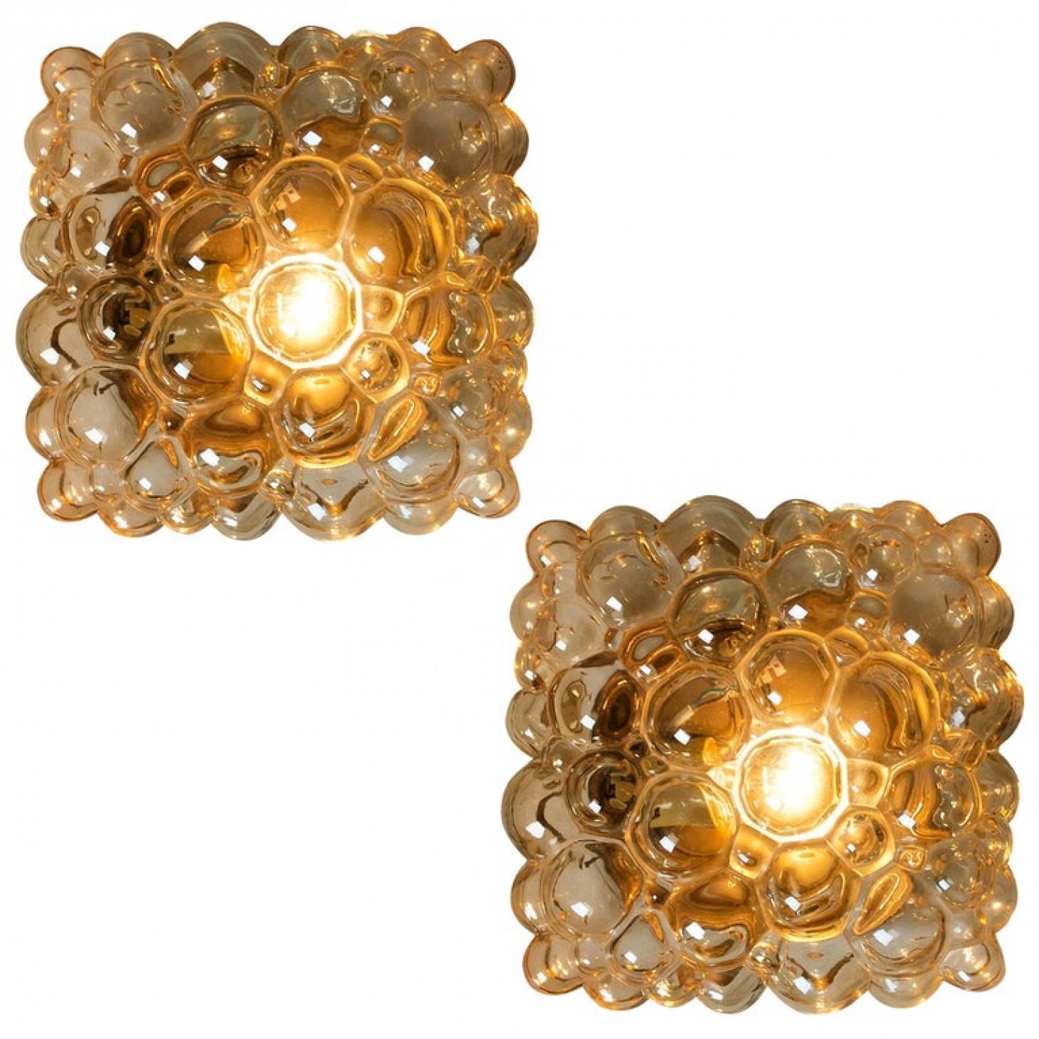 Beautiful high-end large bubble wall lights or flush mounts by Helena Tynell for Glashütte Limburg, Germany, 1960s.
A design Classic, made of glossy amber bubble glass.

The price is for singel one.  Can work as impressive wall lights or ceiling