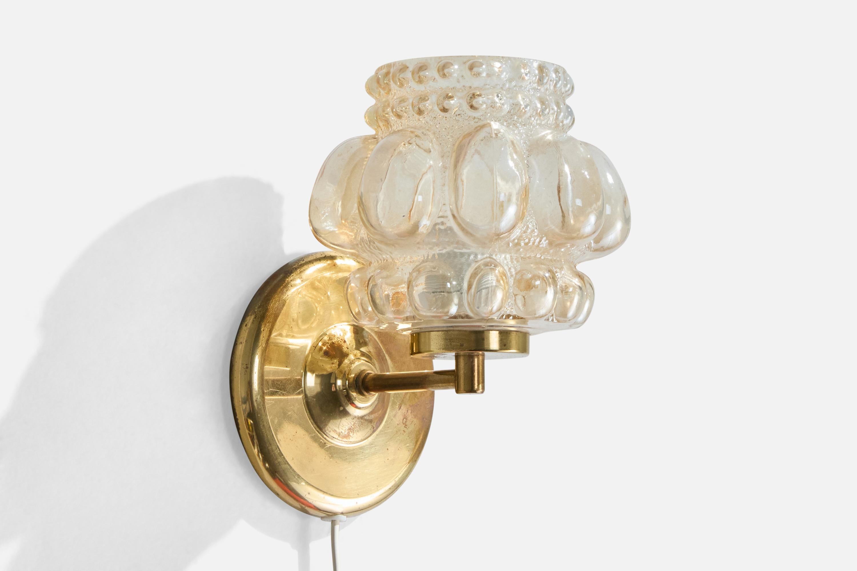 A brass and glass wall light design attributed to Helena Tynell and produced by Ivars, Sweden, c. 1960s

Overall Dimensions (Inches): 8” H x 6” W x 6.6“ D

Back Plate Dimensions (Inches): 5.1” H x 5.1” W x 1.3” D

Bulb Specifications: E-26

Number