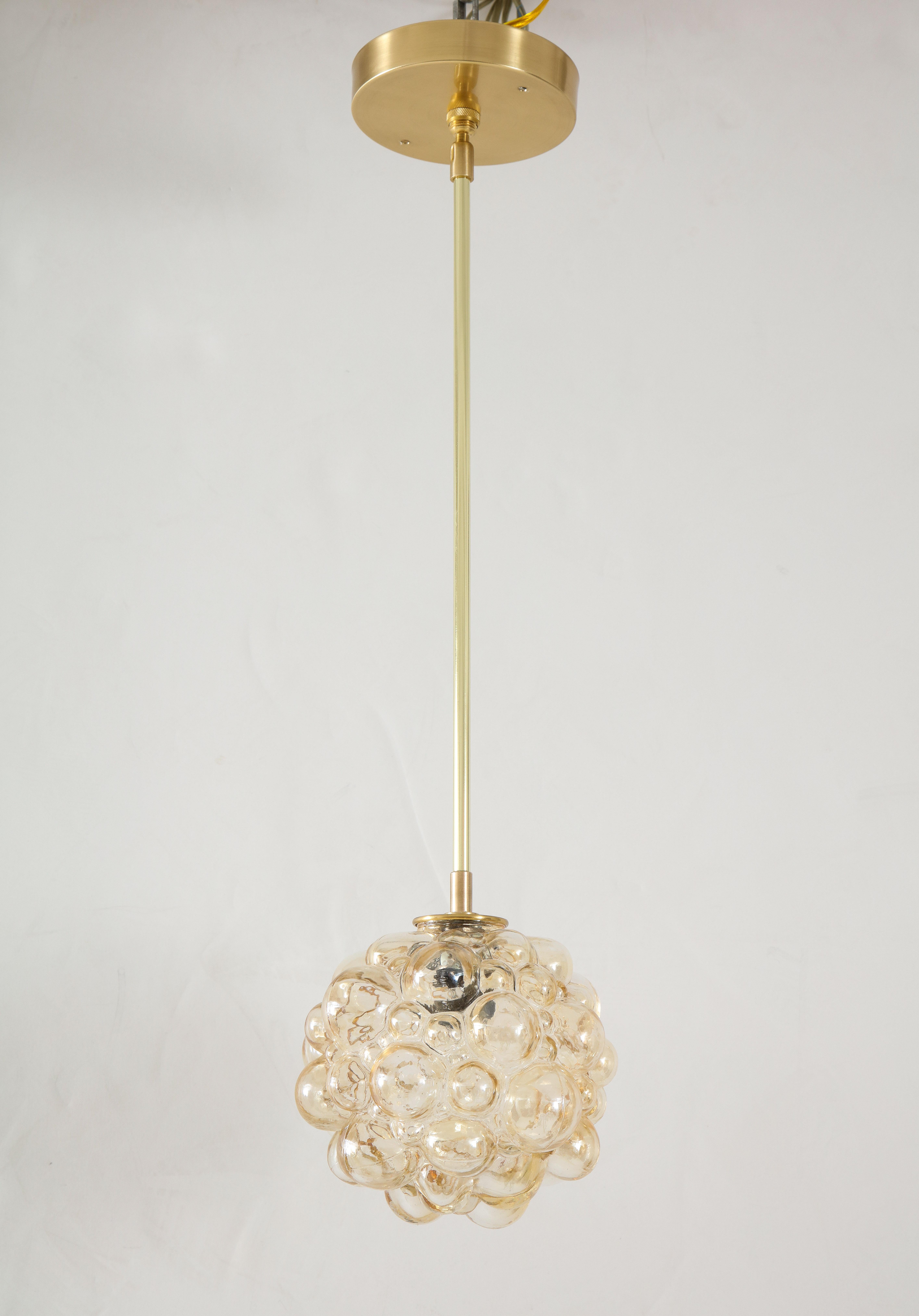 Helena Tynell champagne bubble glass pendants.
The glass globes is supported by a polished brass rod and matching ceiling canopy 
and are Newly rewired with a single candelabra light socket 40 watt Maximum.
The rod is 16
