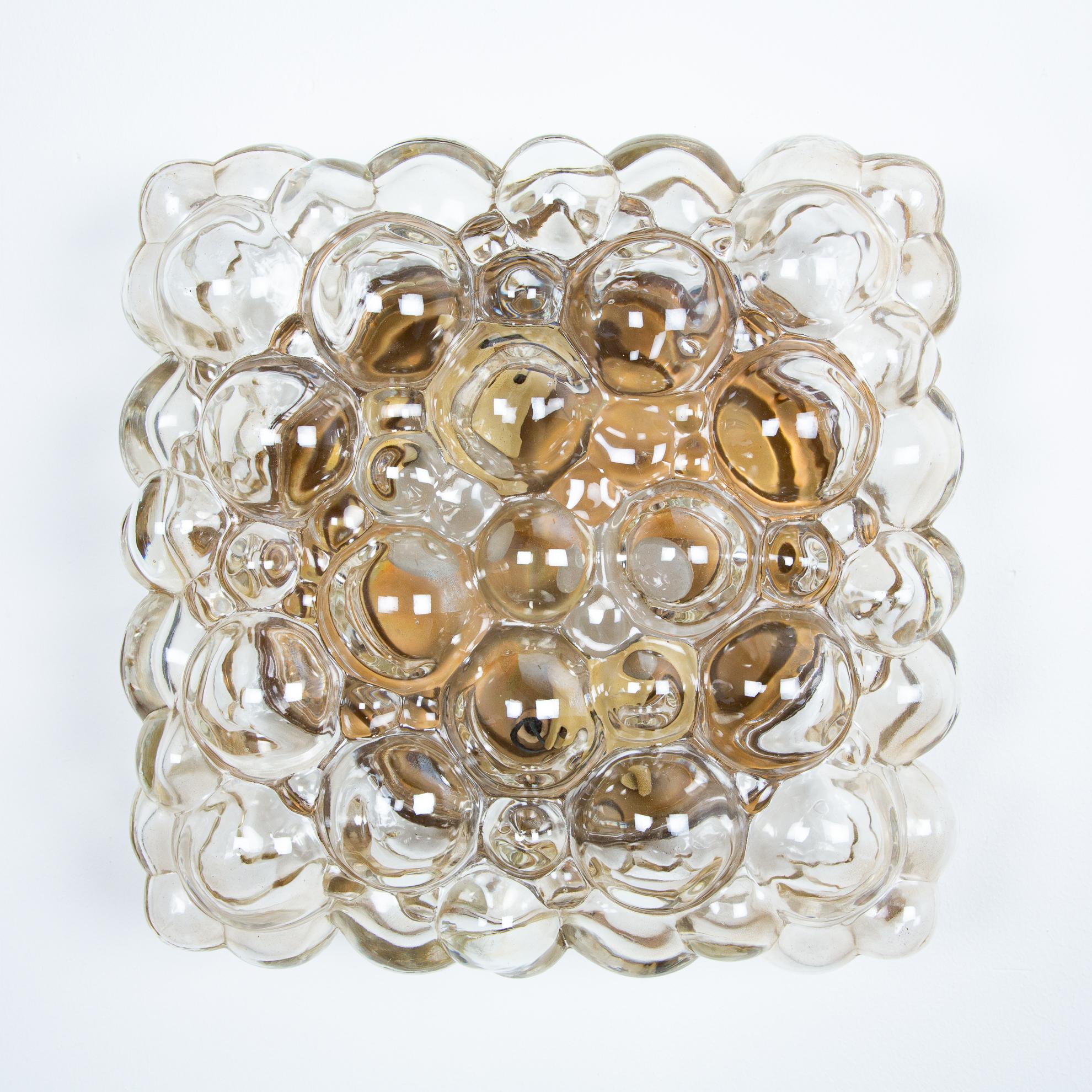 Glass bubble scone of Helena Tynell for Glashüte Limburg. The lamp can be placed as a quadrant horizontal. But also with the edge down or every position between. Also to be used as a ceiling lamp. The bubbles gives a dynamic atmosphere and the light