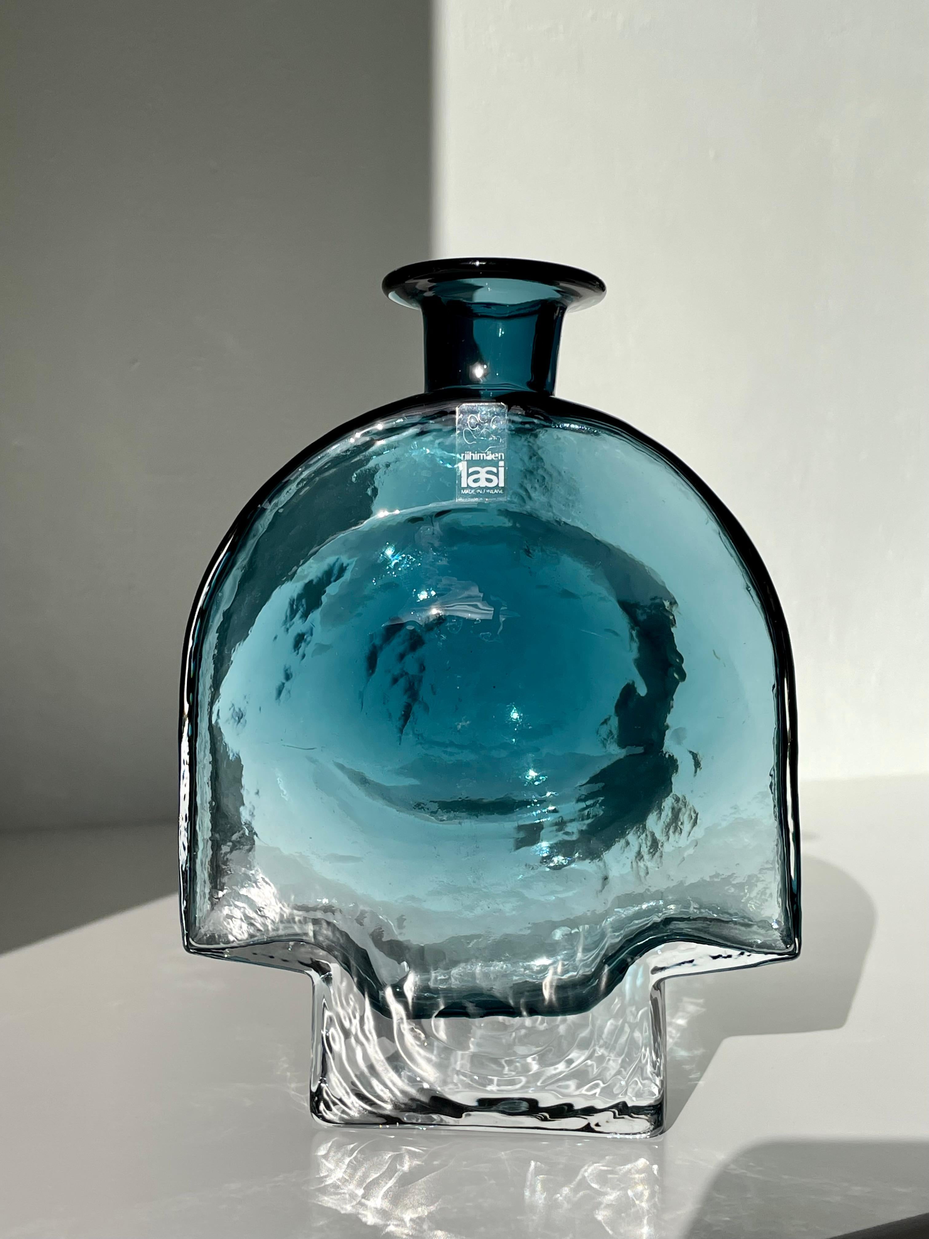 Exceptional handmade art glass vase by artist Helena Tynell for Riihimäen Lasi in the early 1970s. Transparent dusty aqua blue underlay encased in clear glass in an architectural and complex form consisting of round and angled shapes. Original label