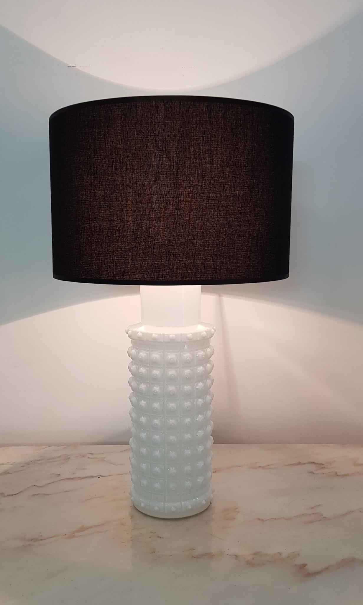 This table lamp feature mold-blown white glass base designed by Helena Tynell for Luxus, Sweden. Variations in glass thickness give the lamps a lovely organic quality. Sticker marked on the top of the base. Luxus, Made in Sweden. Comes with a new