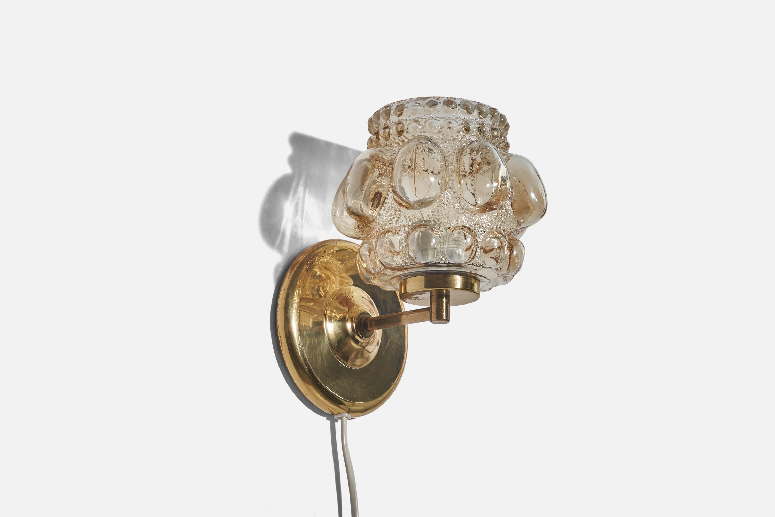 A glass and brass sconce/ wall light designed by Helena Tynell and produced by Glashütte Limburg, Germany, 1960s.

Dimensions of back plate (inches) : 5.11 x 5.11 x 0.70 (height x width x depth).

Socket takes standard E-26 medium base