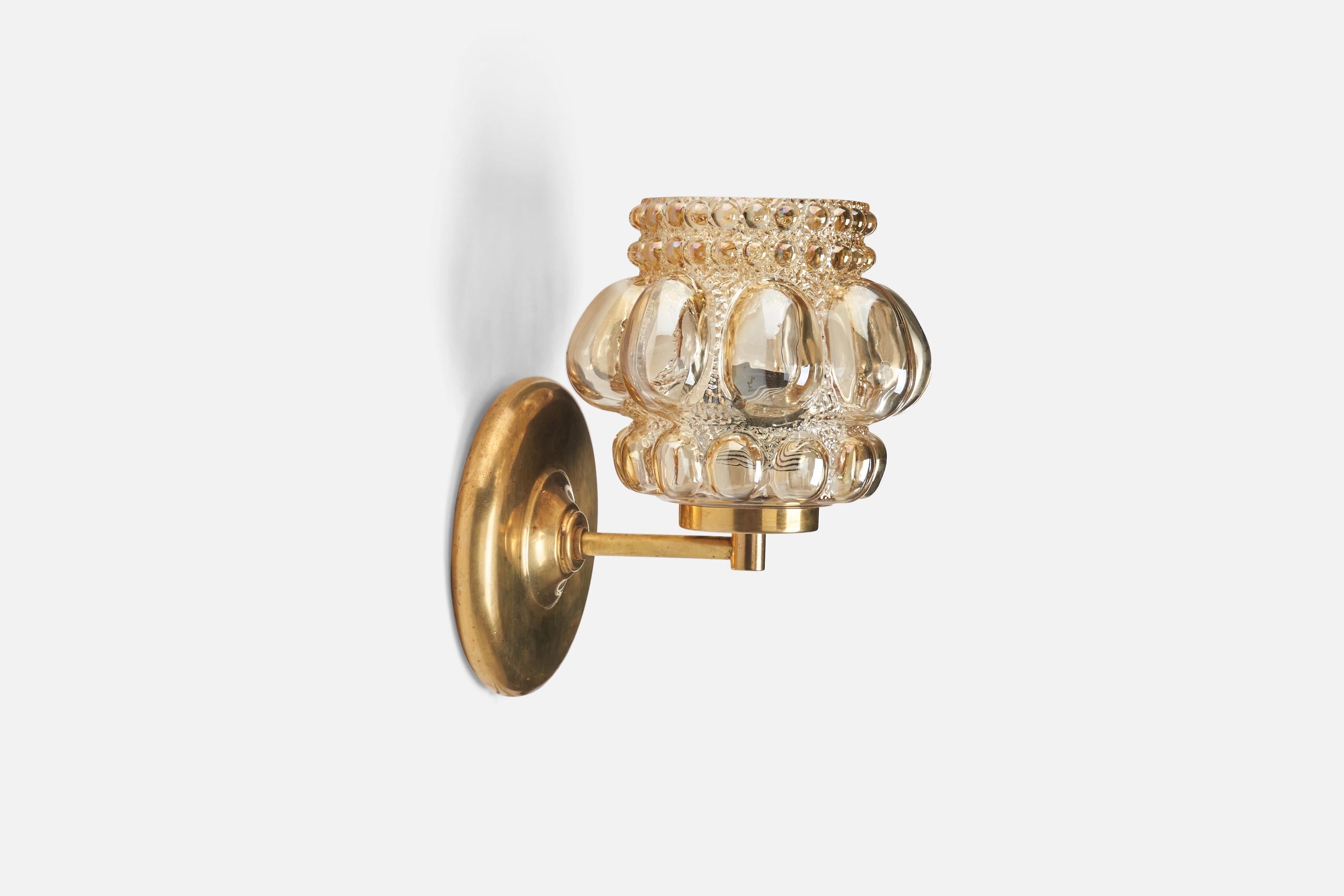A brass and glass wall light designed by Helena Tynell and produced by Glashütte Limburg, Germany, 1960s.
