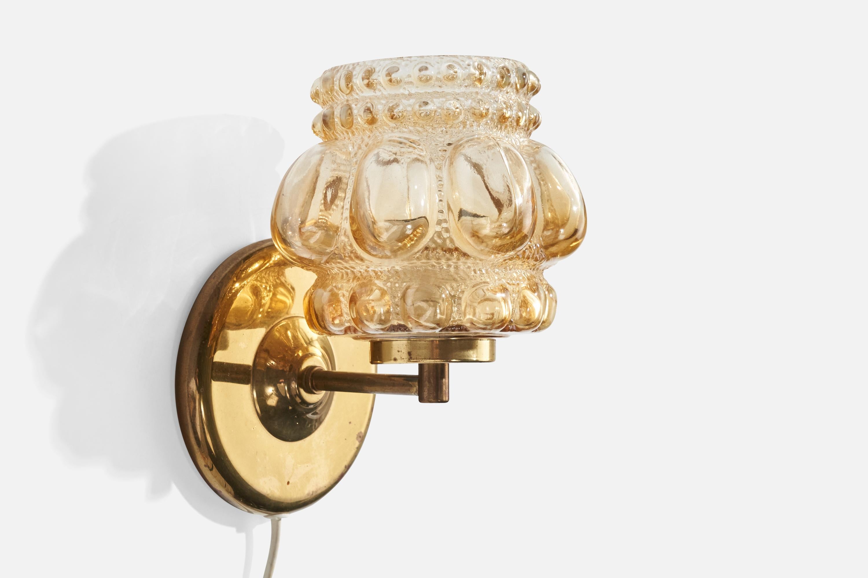 A brass and glass wall light design attributed to Helena Tynell and produced by Ivars, Sweden, c. 1960s

Overall Dimensions (inches):  8” H x 5.5