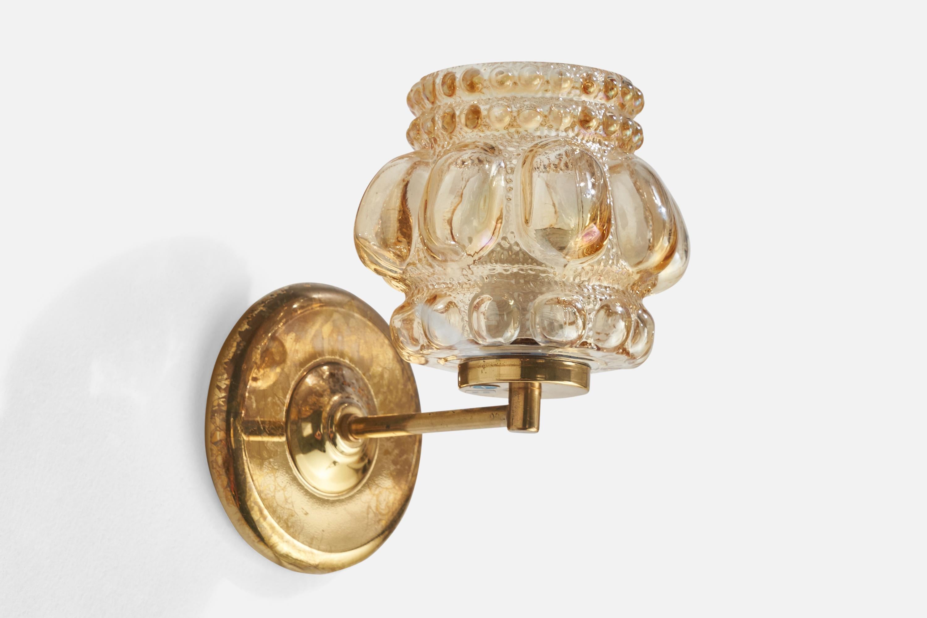 A brass and glass wall light designed by Helena Tynell and produced by Glashütte Limburg, Germany, 1960s.

Overall Dimensions (inches): 8” H x 5.25” W x 7.5” D
Back Plate Dimensions (inches): 5” H x 5” W x .75” D
Bulb Specifications: E-26