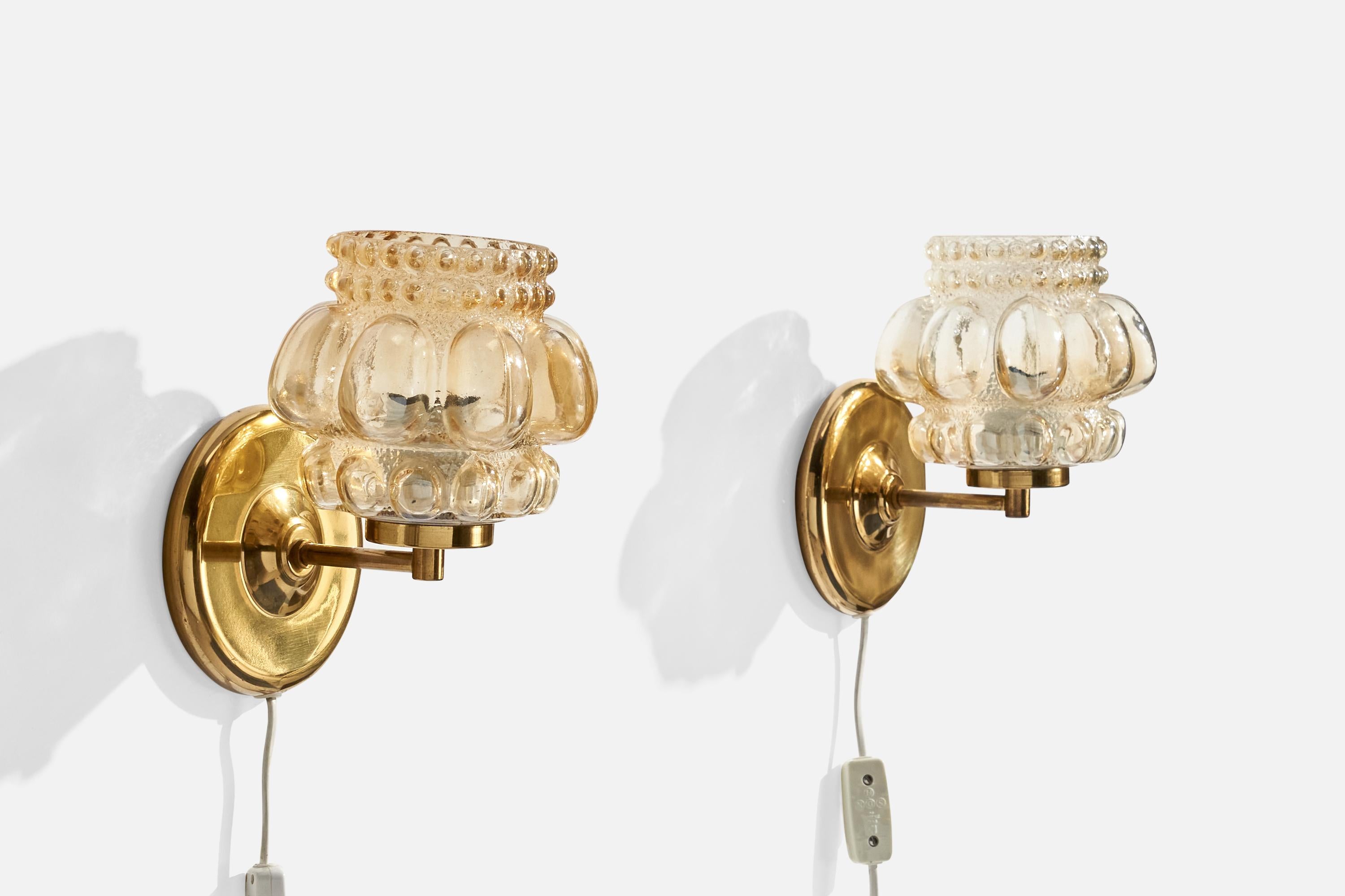 A pair of brass and glass wall lights design attributed to Helena Tynell, produced by Ivars, Sweden c. 1960s.

Overall Dimensions (inches):  8.25” H x  6.375” W x  6.25“D
Back Plate Dimensions (Inches):  5.125” Diameter x .75” D
Bulb Specifications: