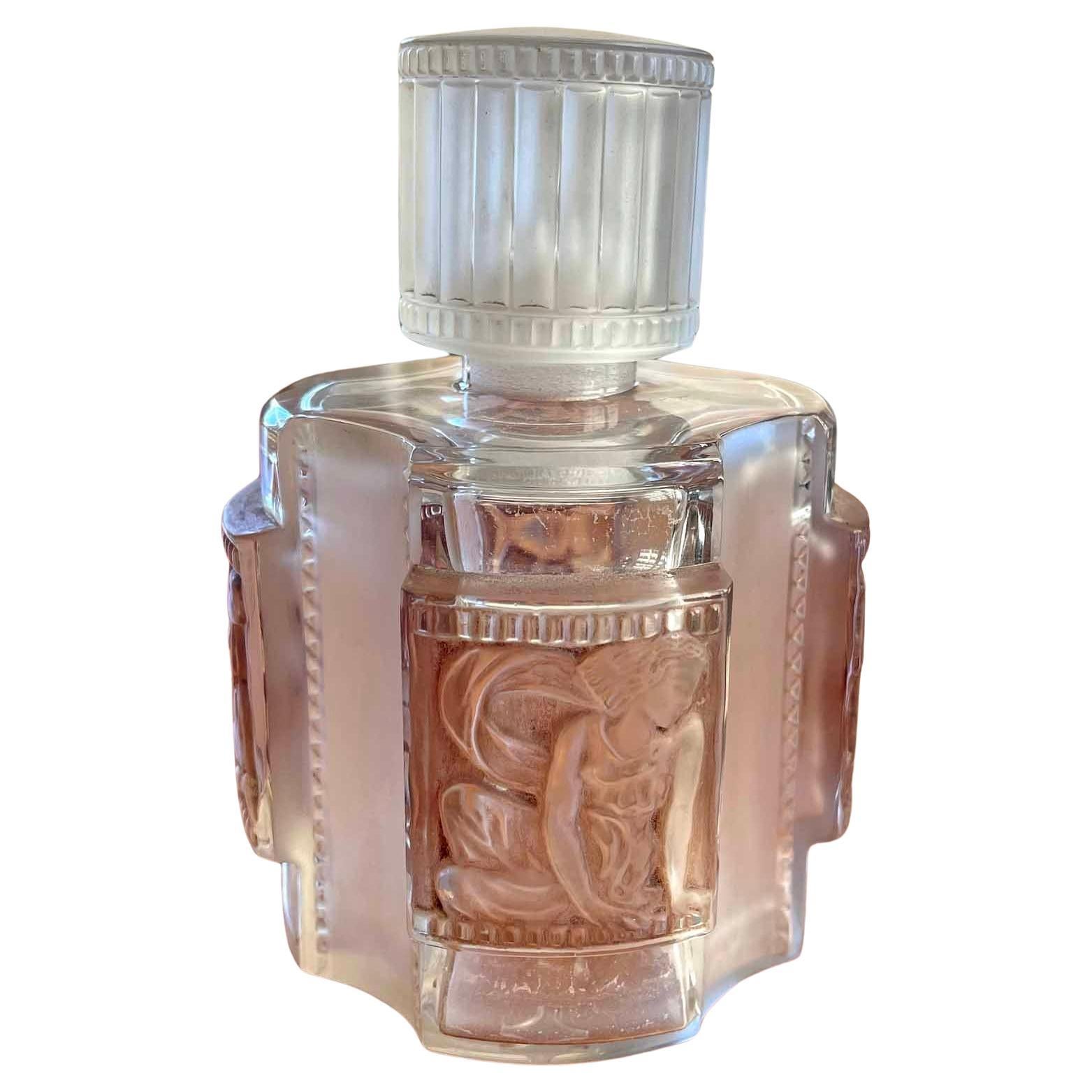 Although René Lalique -- France's greatest designer in glass in the 1920s, 30s and 40s -- made many bottles for the leading perfumiers of the day, the Helene bottle from 1942 is one of his loveliest.  The cylindrical body is decorated with four