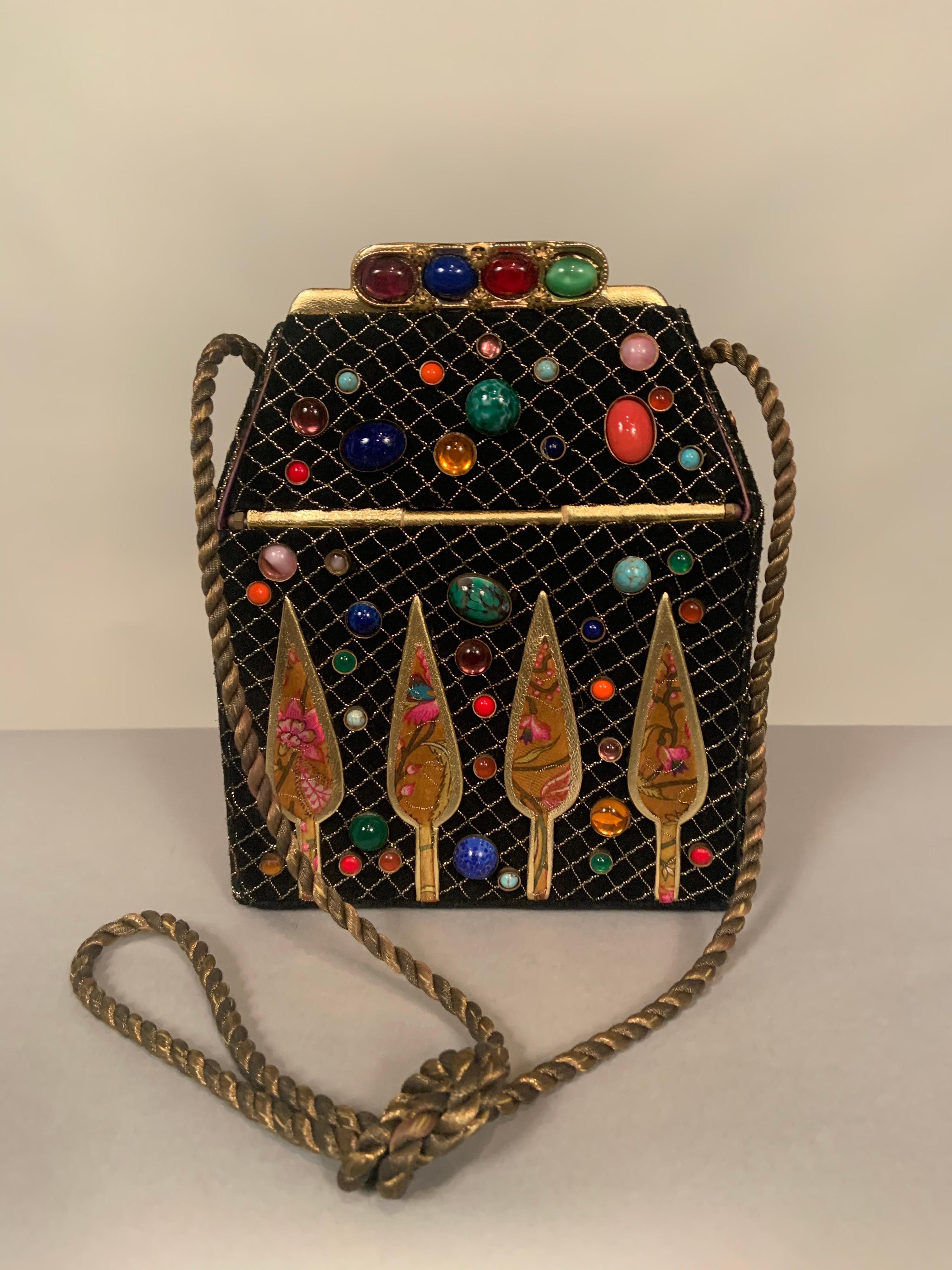 Helene Angeli located in Nice, in the South of France, designs fanciful handbags in the shape of familiar objects. This black suede bag is inspired by a beautiful house. The suede is covered with a lattice of metallic gold thread in a nod to