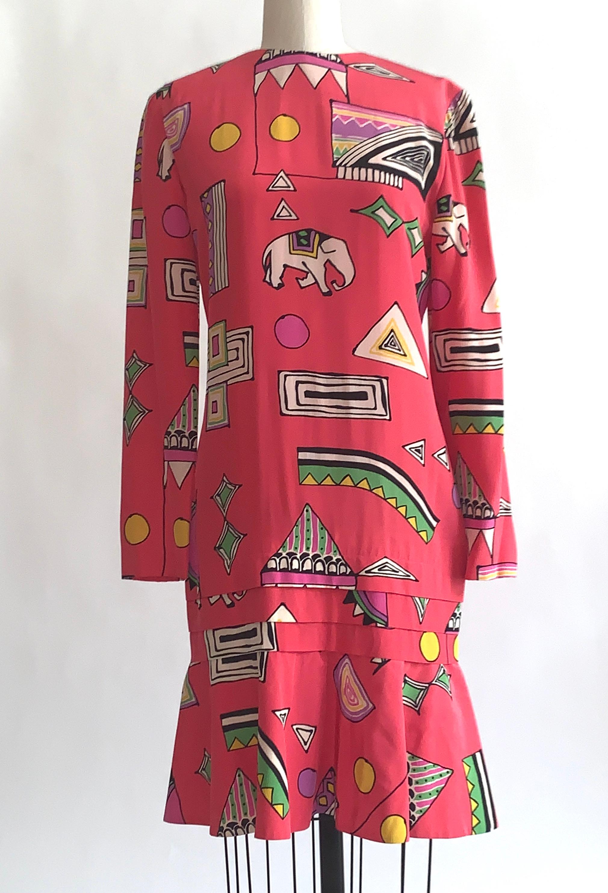 Helga bright pink vintage dress with vibrant multi color abstract circus print throughout featuring elephants and circus tents. Flounced hem with pleat detail above. Long sleeve. Back zip. 

No content label, feels like silk, but could be a blend.