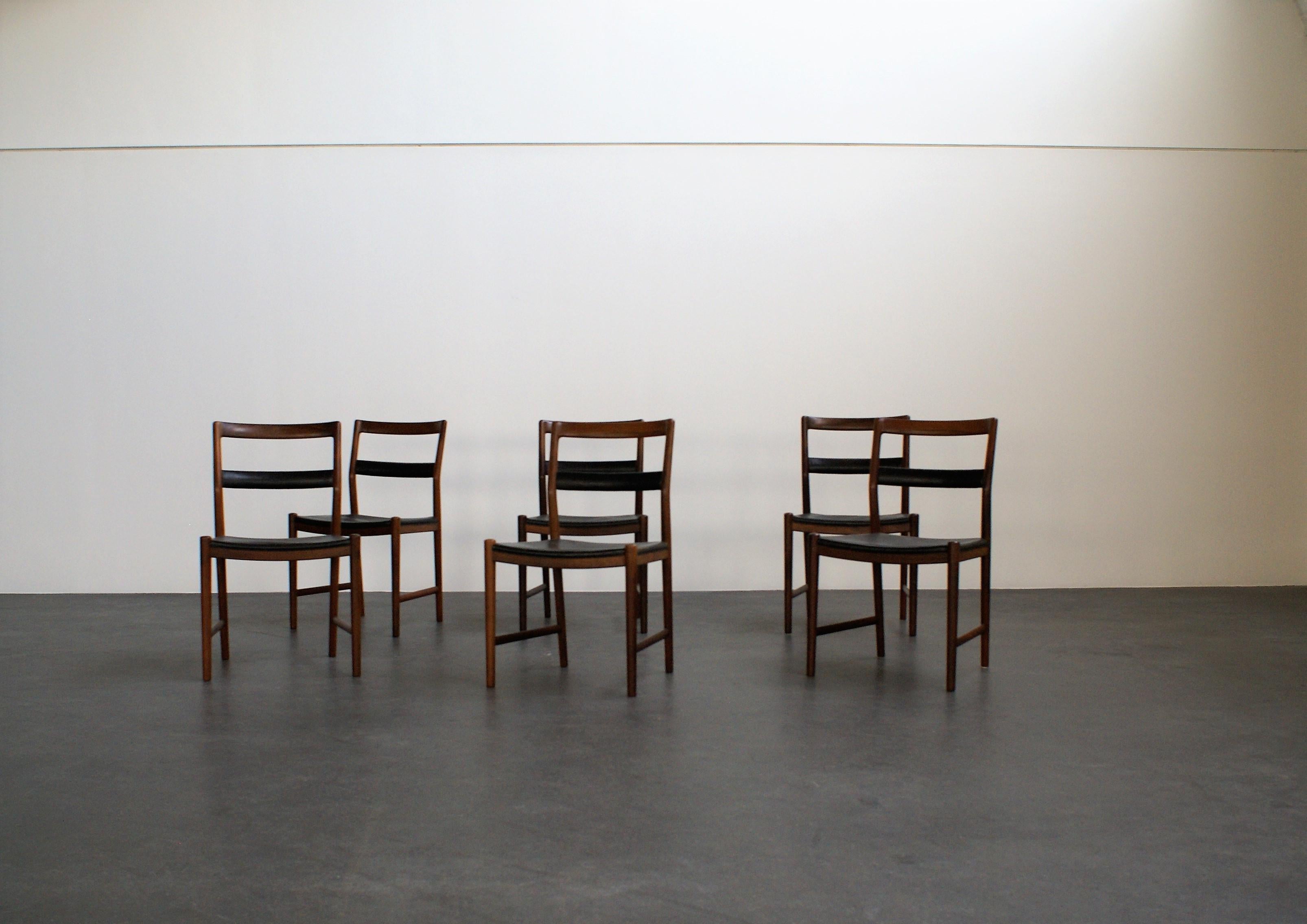 Set of six dining chairs designed by Helge Vestergaard-Jensen and executed by master cabinetmaker Søren Horn, marked from maker. Upholstery in original patinated black leather.

This model was presented at The Copenhagen Cabinetmakers' Guild