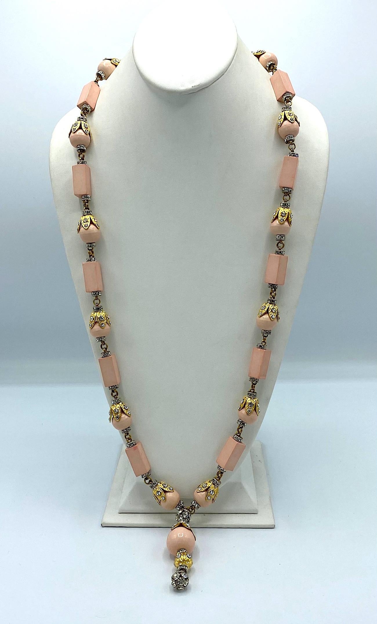 A beautiful faux coral pink bead necklace by Italian Princepessa Helietta Caracciolo from the mid 1970s. It is costructed of .63 of an inch diameter round and .38 of an inch square by .88 of an inch long faux angel skin pin lucite bead. The round