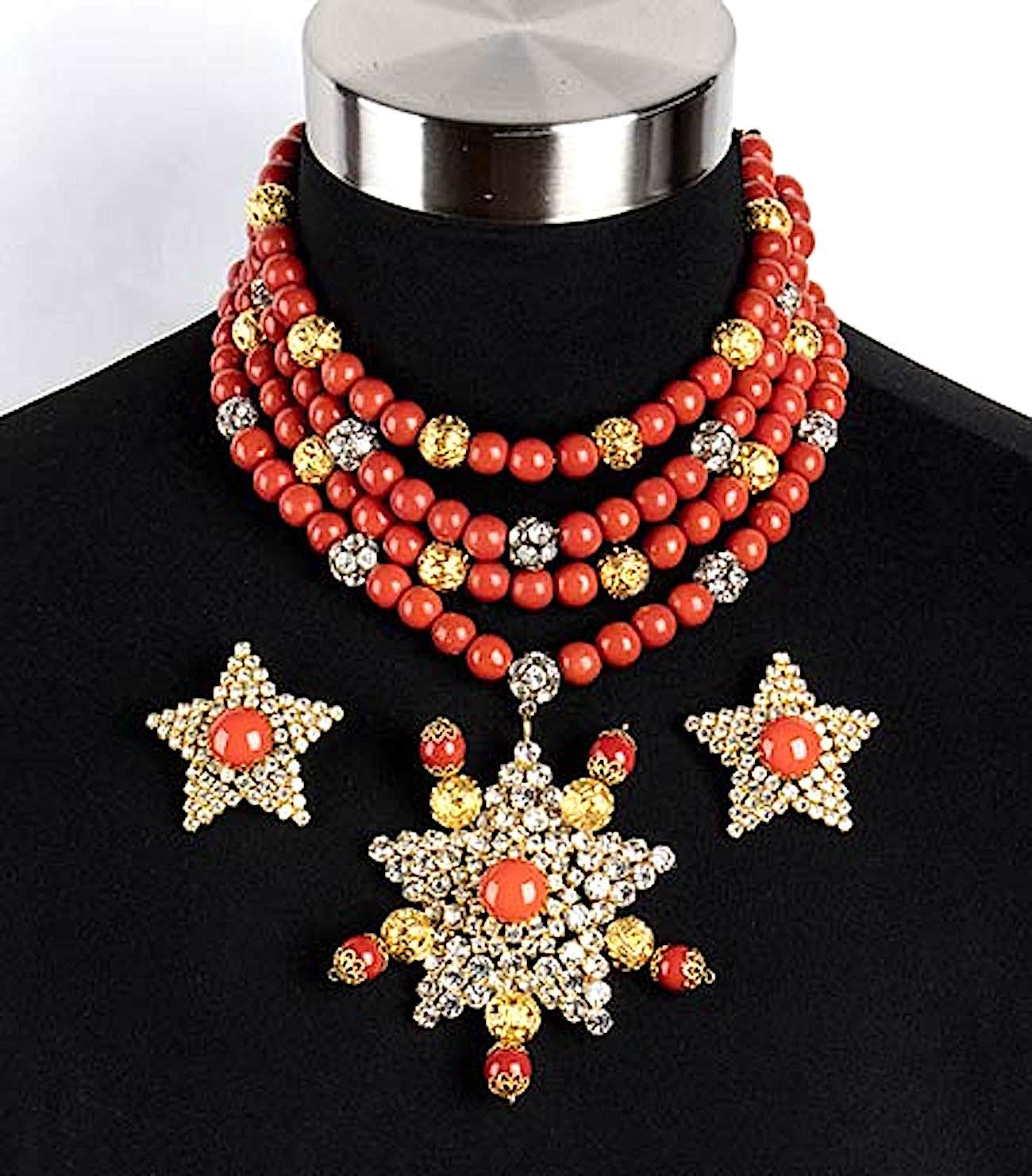 
A truly remarkable choker or dog collar style necklace from the 1970s by Princess Helietta Caracciolo. Four strands of faux red coral resin beads are strung on wire with gold and rhinestone set beads. They end with a multi strand hook and eye
