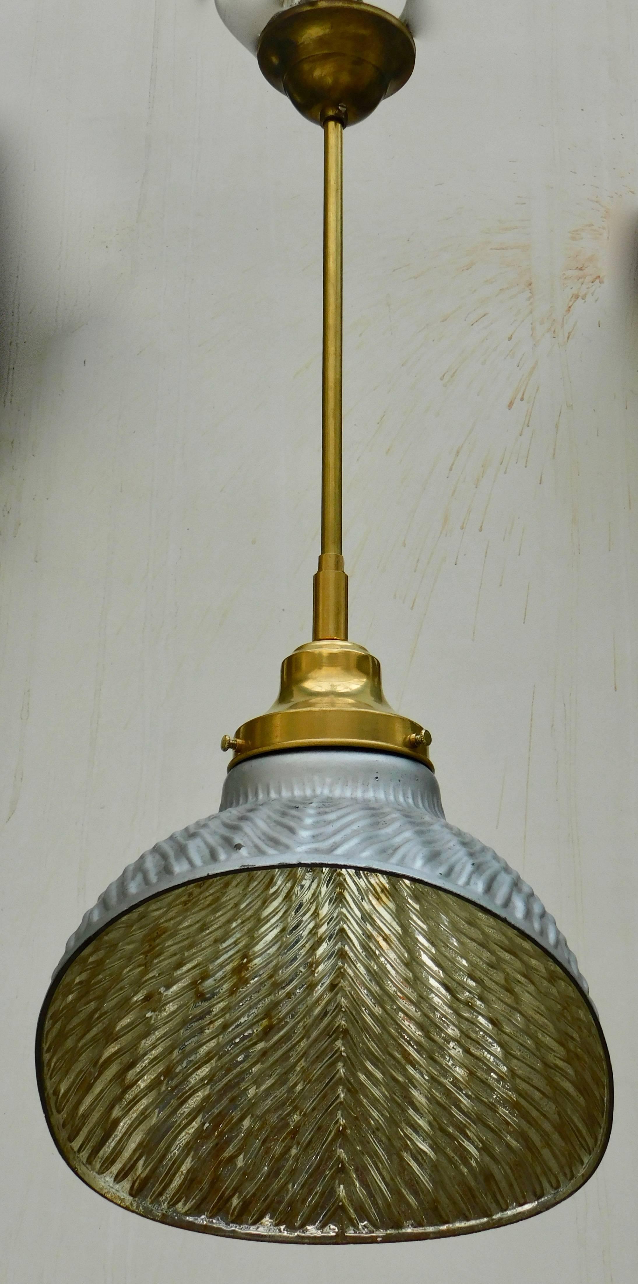 Mercury glass hanging lampshade made by Helioray in the first part of the 20th century for use to reflect and brighten overhead light for surgery and examinations.
The exterior retains the original grey paint and the Helioray label.
Renewed and