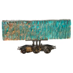 Helios, iridescent cast glass & model train steam chassis sculpture by Jon Lewis