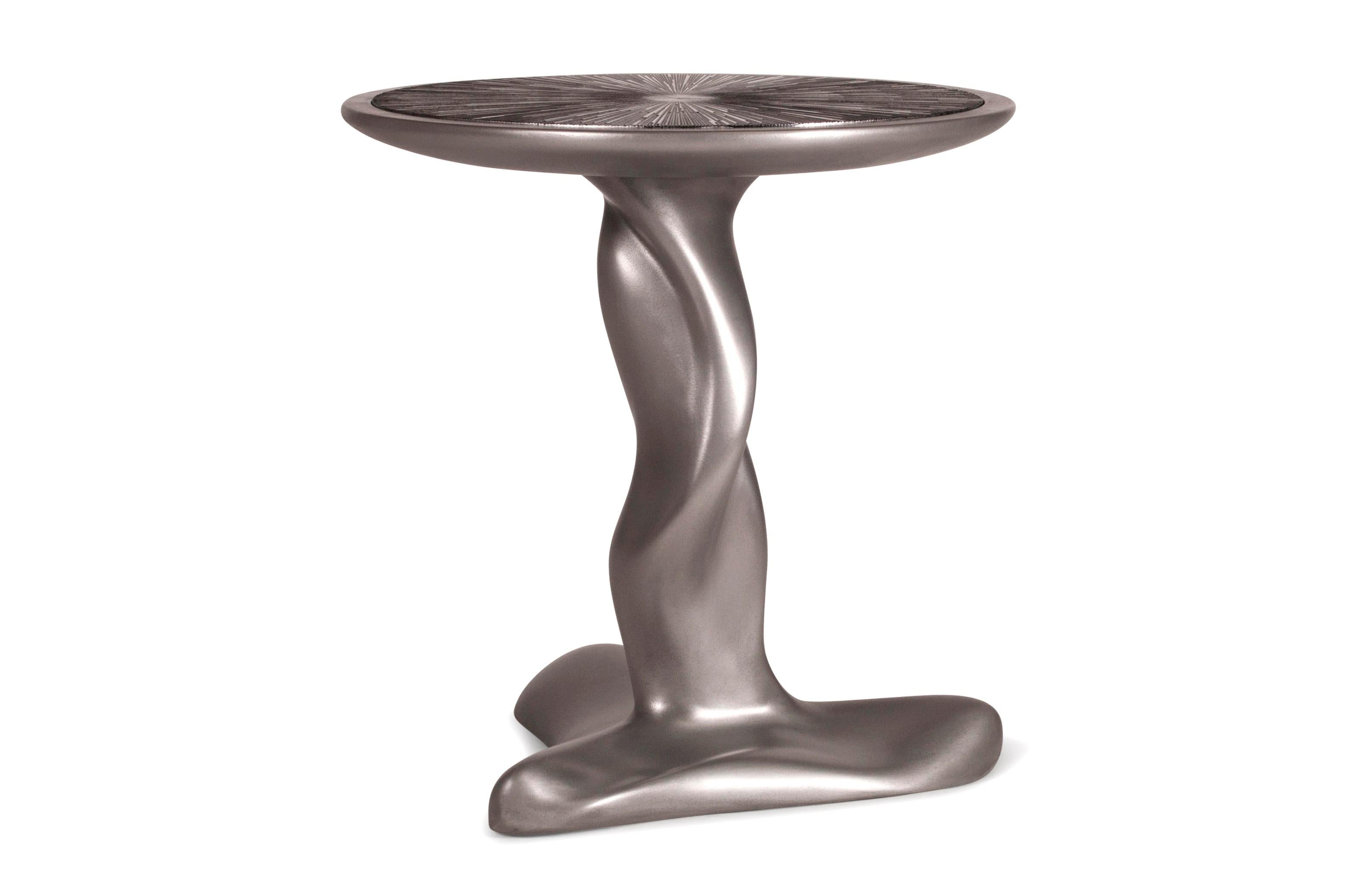 Helios side table is polished stainless steel finish from our unique metal finish. The top is lacquered black with silver leaf gilding. Custom finish and sized available.

About Amorph: 
Amorph is a design and manufacturing company based in Los