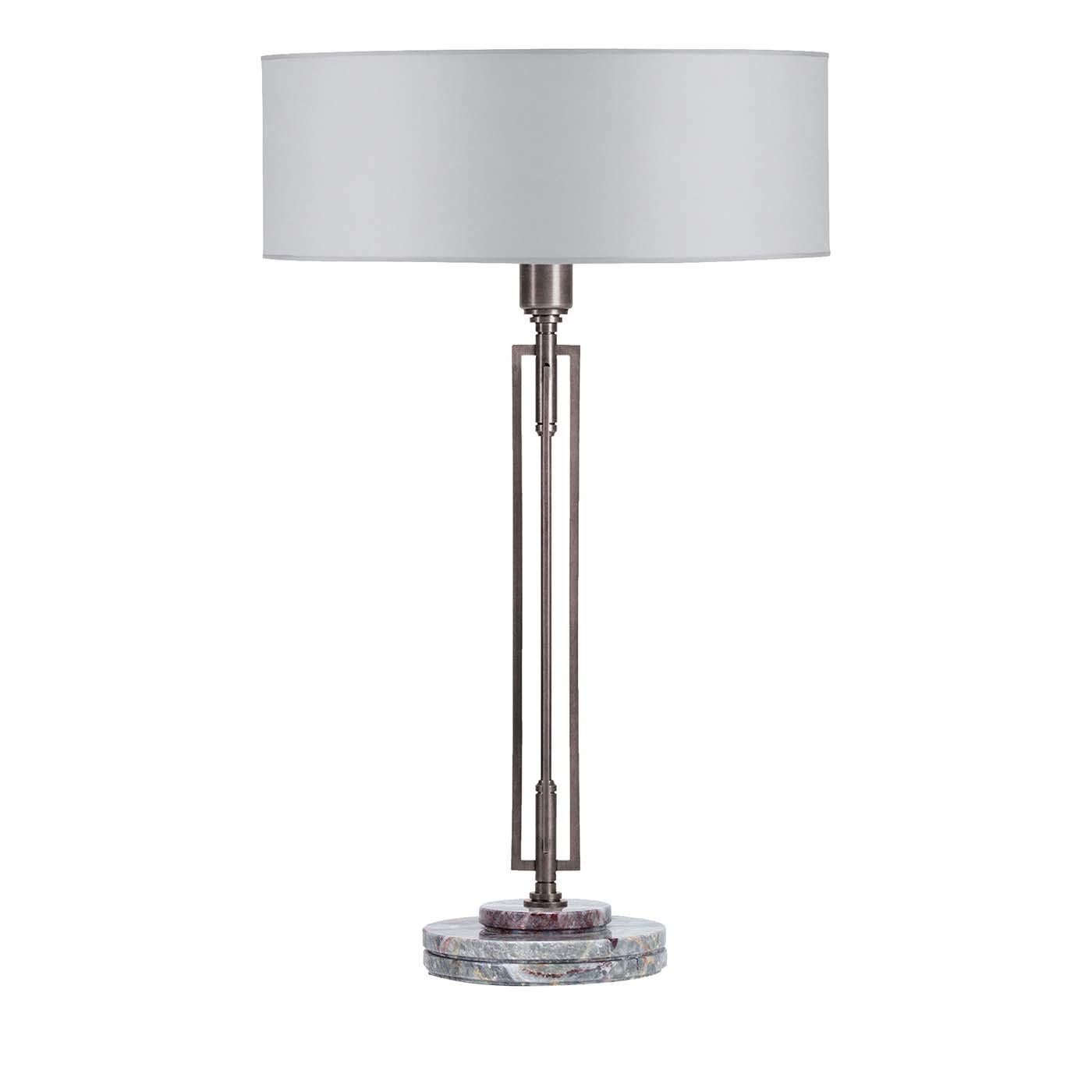 Marked by a clean-lined silhouette and contemporary flair, this splendid table lamp showcases a stunning drum shade made of light gray silk that sits up above a steel structure with a slender rod in an open, rectangular frame. Diffusing the light