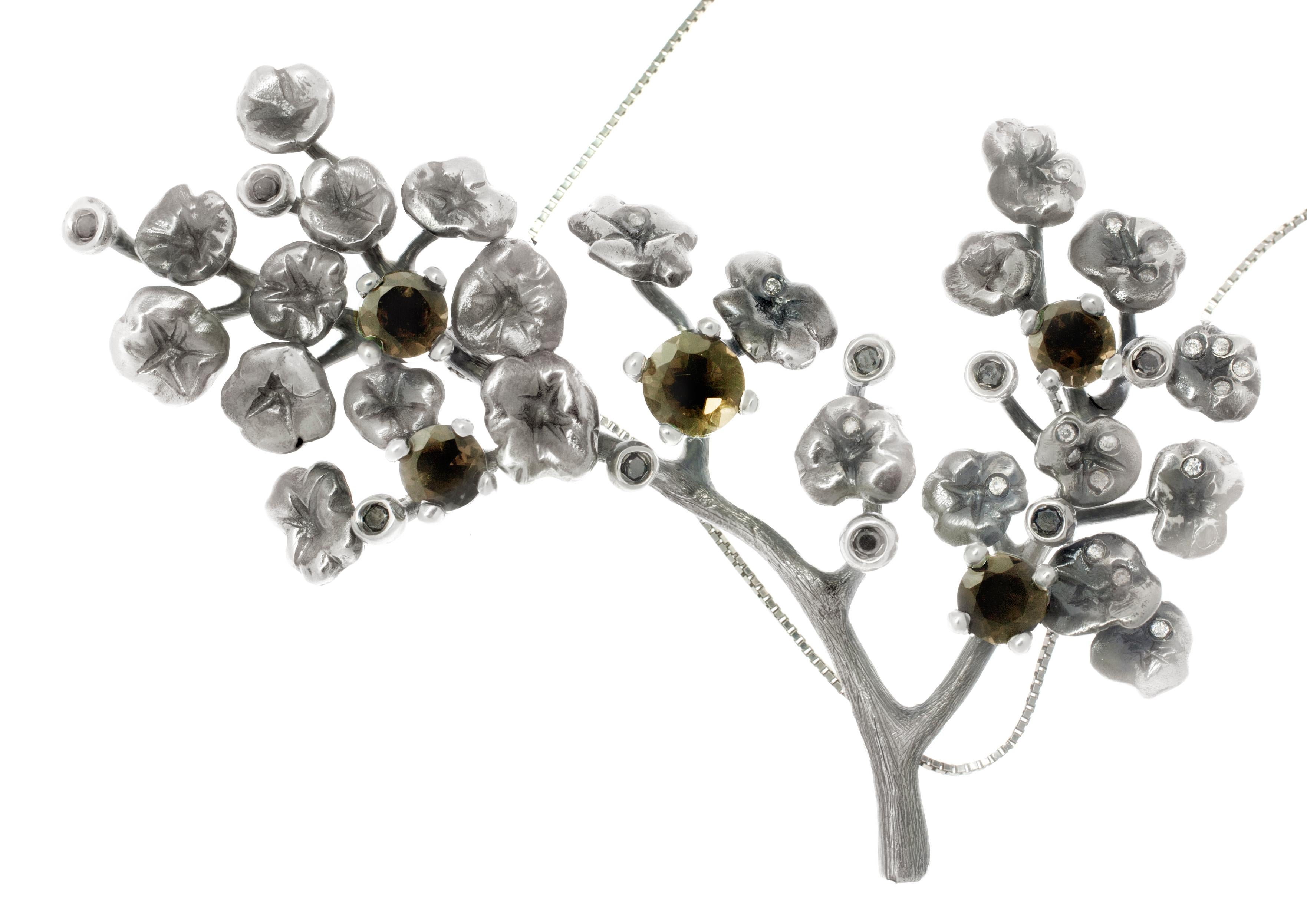 This beautiful Heliotrope contemporary necklace by the artist features 34 white and black diamonds and 5 smoky quartz stones. Made from dark silver, this piece exudes a designer, new gothic look that is unique and eye-catching. The diamonds and