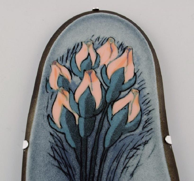 Heljä Liukko-Sundström (b. 1938) for Arabia.
Glazed faience wall plaque with hand-painted flowers. 
Finnish design. Dated 1981.
Measures: 23.7 x 11 cm.
In excellent condition.
Signed.