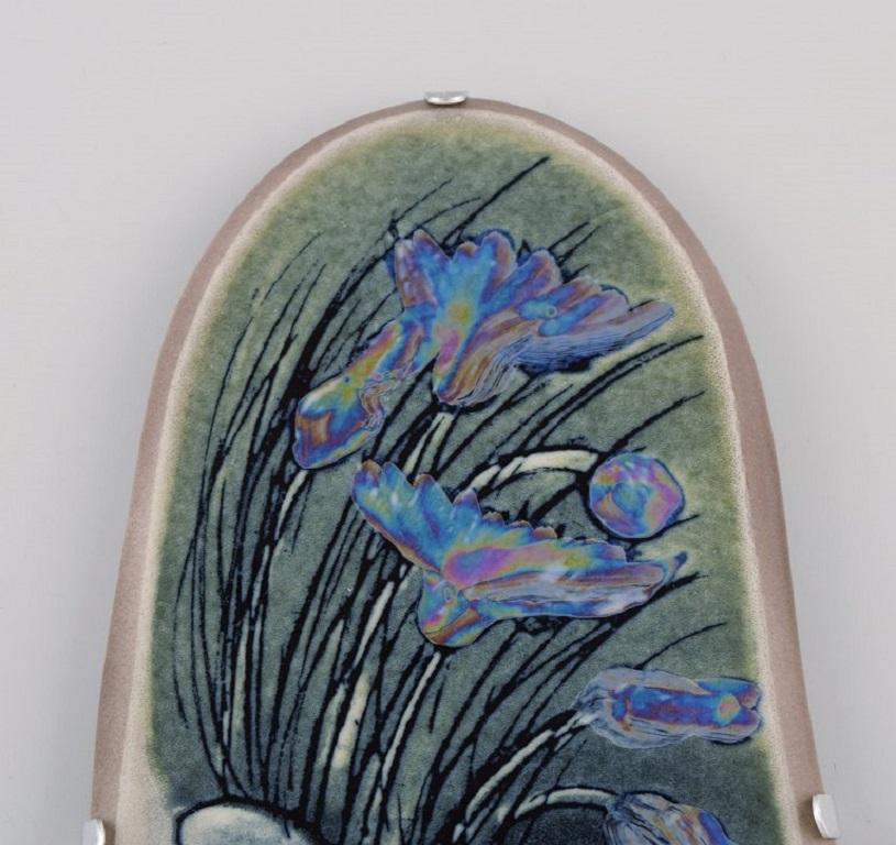Heljä Liukko-Sundström (b. 1938) for Arabia. 
Glazed faience wall plaque with hand-painted flowers. Finnish design. Dated 1987.
Measures: 23.5 x 11 cm.
In excellent condition.
Signed.