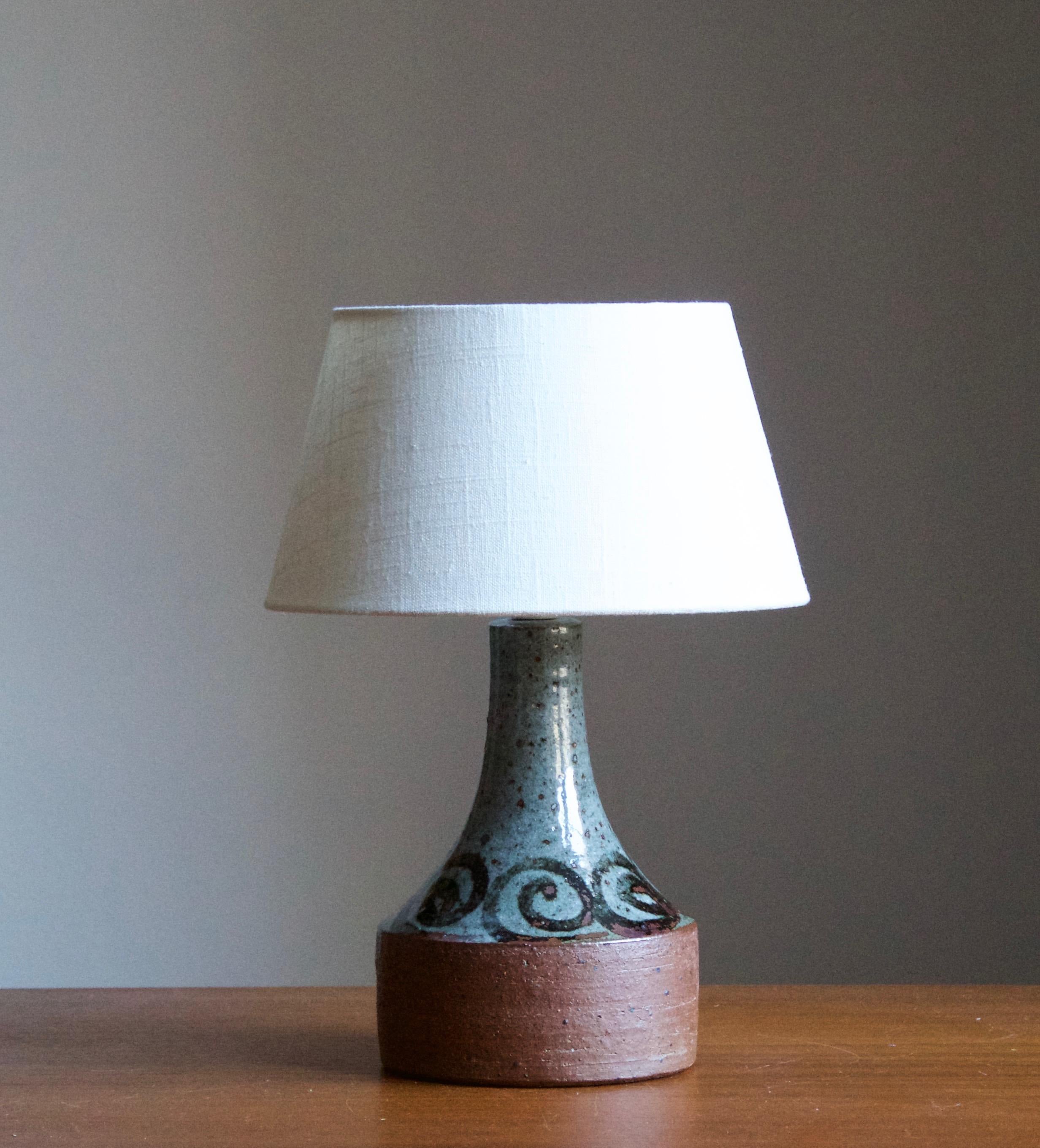 A pair of table lamps designed and produced by Helle Allpass in her studio, Denmark, 1960s. Features a highly artistic glaze. Stamped

Stated dimensions exclude lampshades. Height includes socket. Sold without lampshades.