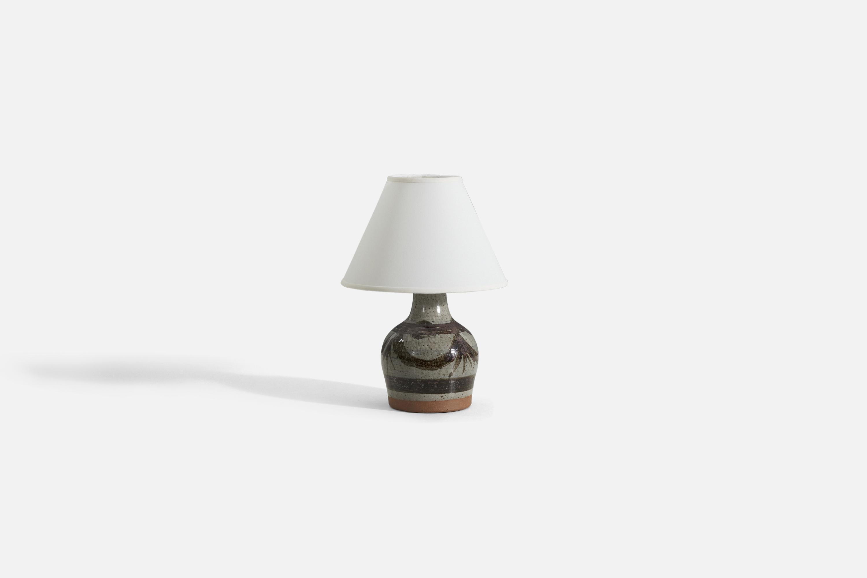 A gray and brown glazed stoneware table lamp, designed and produced by Helle Allpass, Denmark, 1960s.

Sold without lampshade.
Measurements listed are of lamp itself. 
Measurements of shade : 5 x 12.25 x 8.75 - (T x B x S)
Measurements with