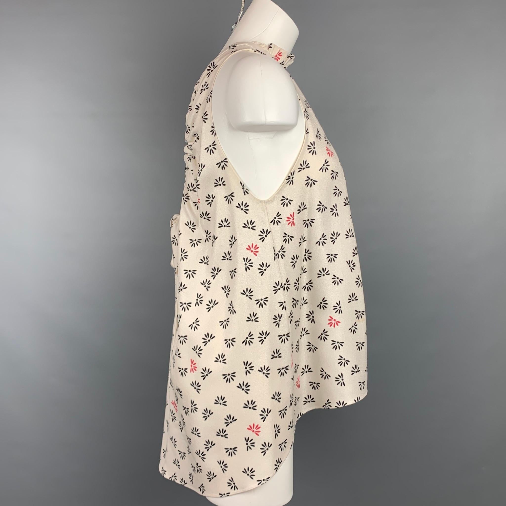 HELLESSY blouse comes in a cream & black crepe floral silk featuring a back tie detail, sleeveless, pleated, and a hook & loop closure. 

Very Good Pre-Owned Condition.
Marked: 2
Original Retail Price: $820.00

Measurements:

Bust: 38 in.
Length: