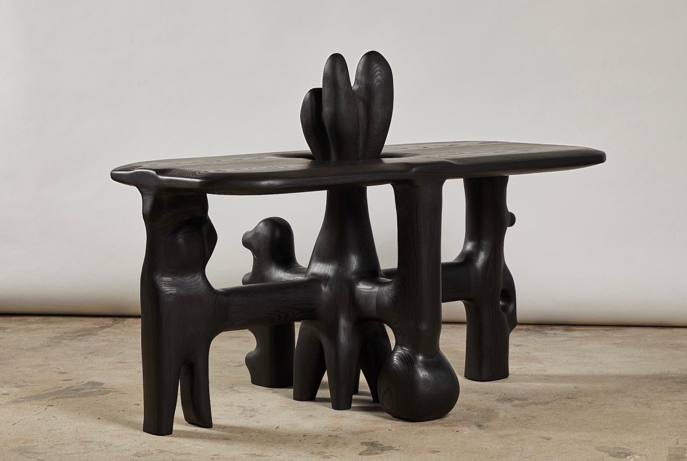 Organic hand carved sculptural coffee table in oiled black walnut. Made in the USA by Casey McCafferty.

Can be customized with additional cost.

Pictures shown of this sculptural piece are a depiction what yours could look like. 

This piece