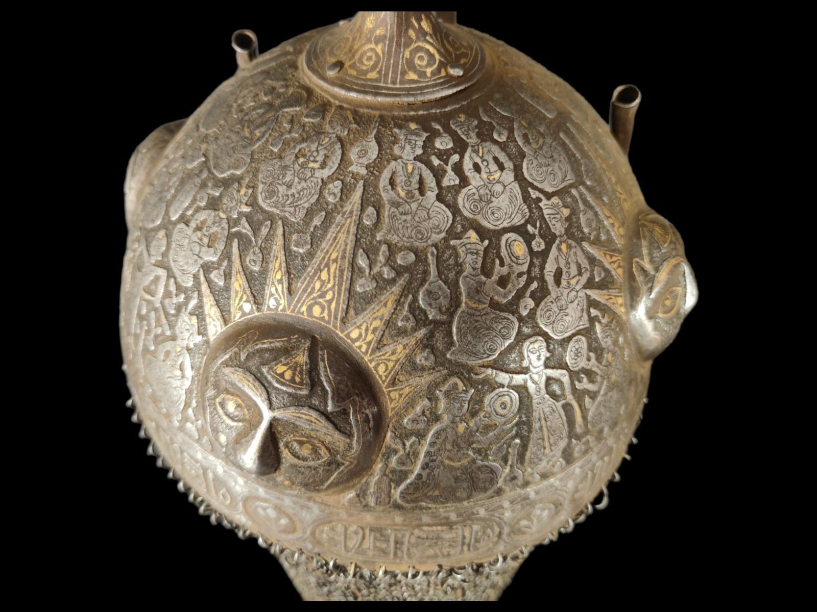 Helmet (Khula Khud) XIX century. Persia, Guajar. Made in damascus steel with silver and golden thread. Decorated with scenes of Persian palace life and several suns around in relief. Also has a damask calligraphy on the bottom. Noticed by its rarity
