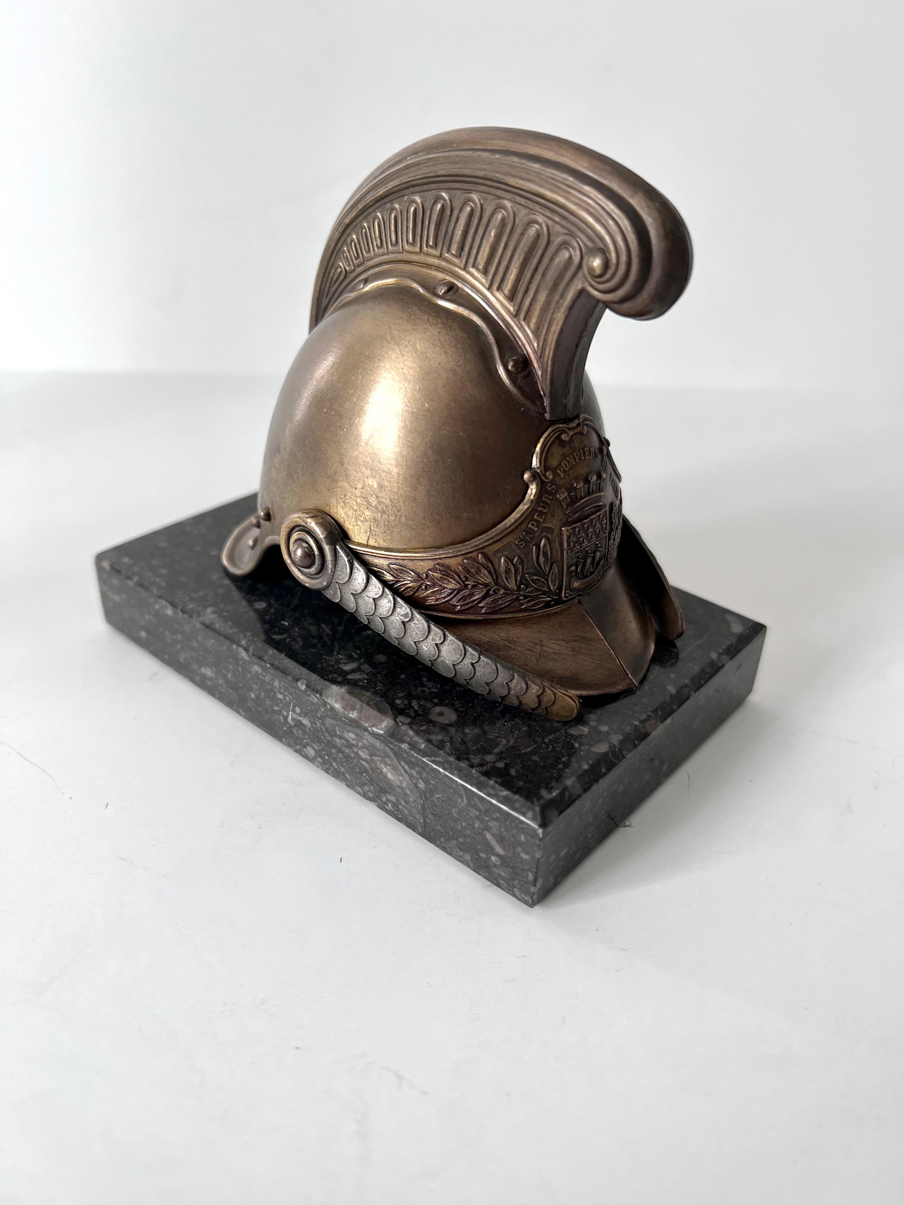 Acquired in Paris France, this is a wonderful paperweight. A Helmut mounted on a piece of marble - a compliment to any desk or work station. The helmet is metal and the sides move a bit, as they are supposed to. A great curiosity, wonderful for a