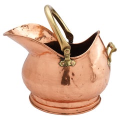 Antique Helmet shaped copper coal hod on a circular footed base, 1800's