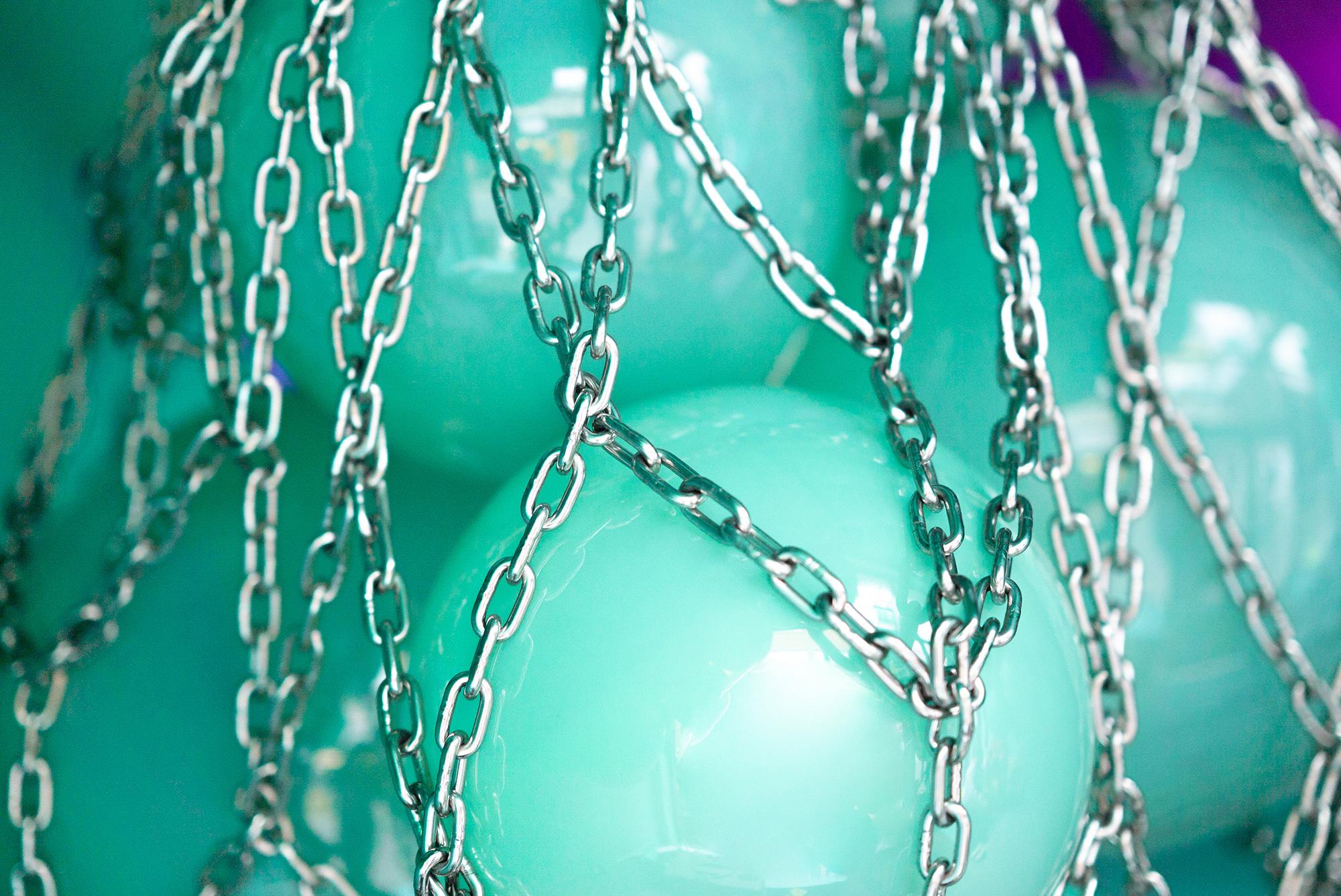 Helmi hand blown glass and silver net contemporary chandelier, made up of 8 hand blown glass green peals in a steel net.

The Helmi, meaning ‘pearl’ in the mother tongue of designer Ian Cameron, was conceived during a fishing trip near his Finnish