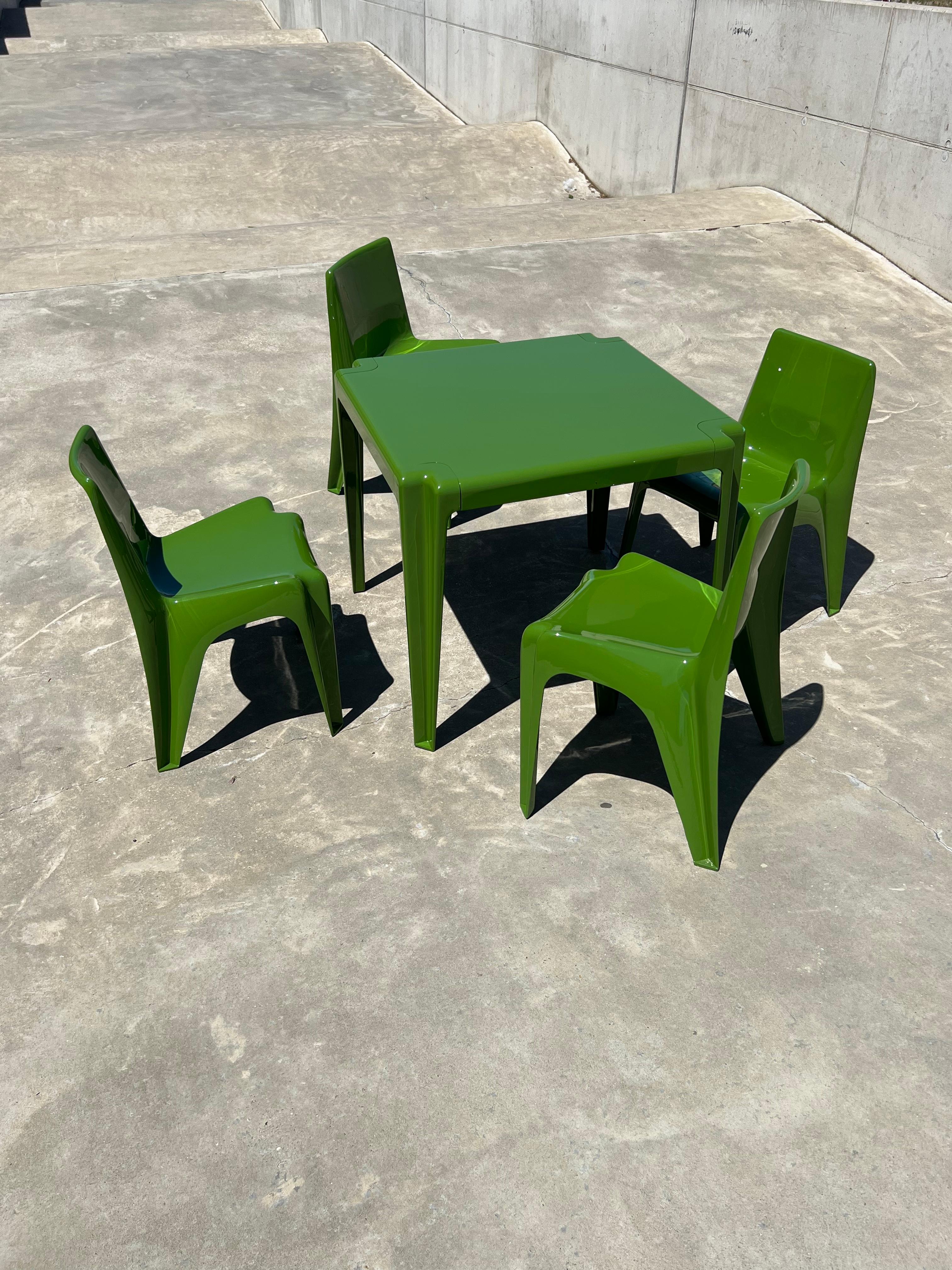 Super cute set of four chairs and a table made out of fibreglass designed by Helmut Bätzner for Bofinger, made in Germany in the 60s. The table as well as the chairs are marked with the Bofinger stamp on the bottom. 

The Bofinger stacking chair was