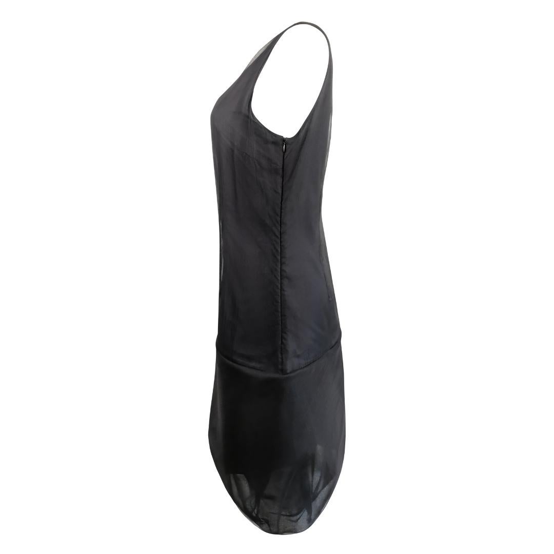 This iconic and very rare vintage Helmut Lang silk organza balloon shift dress from the Spring/Summer 2000 collection is a true masterpiece of minimalist design. Crafted from sheer black silk organza, the dress features a sleeveless silhouette with