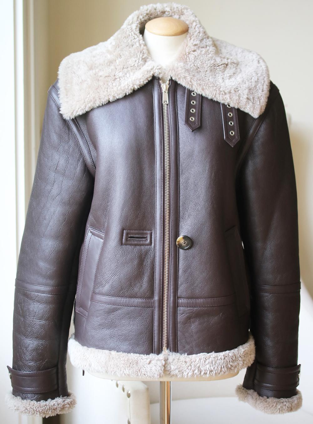 It has all the details of the time-honored style, including buckled trims and pockets. Brown and green shearling. Zip fastening through front. 100% shearling (Lamb). Trim: 100% leather (Calf). 

Size: Medium (UK 10, US 6, FR 38, IT 42)

Condition: