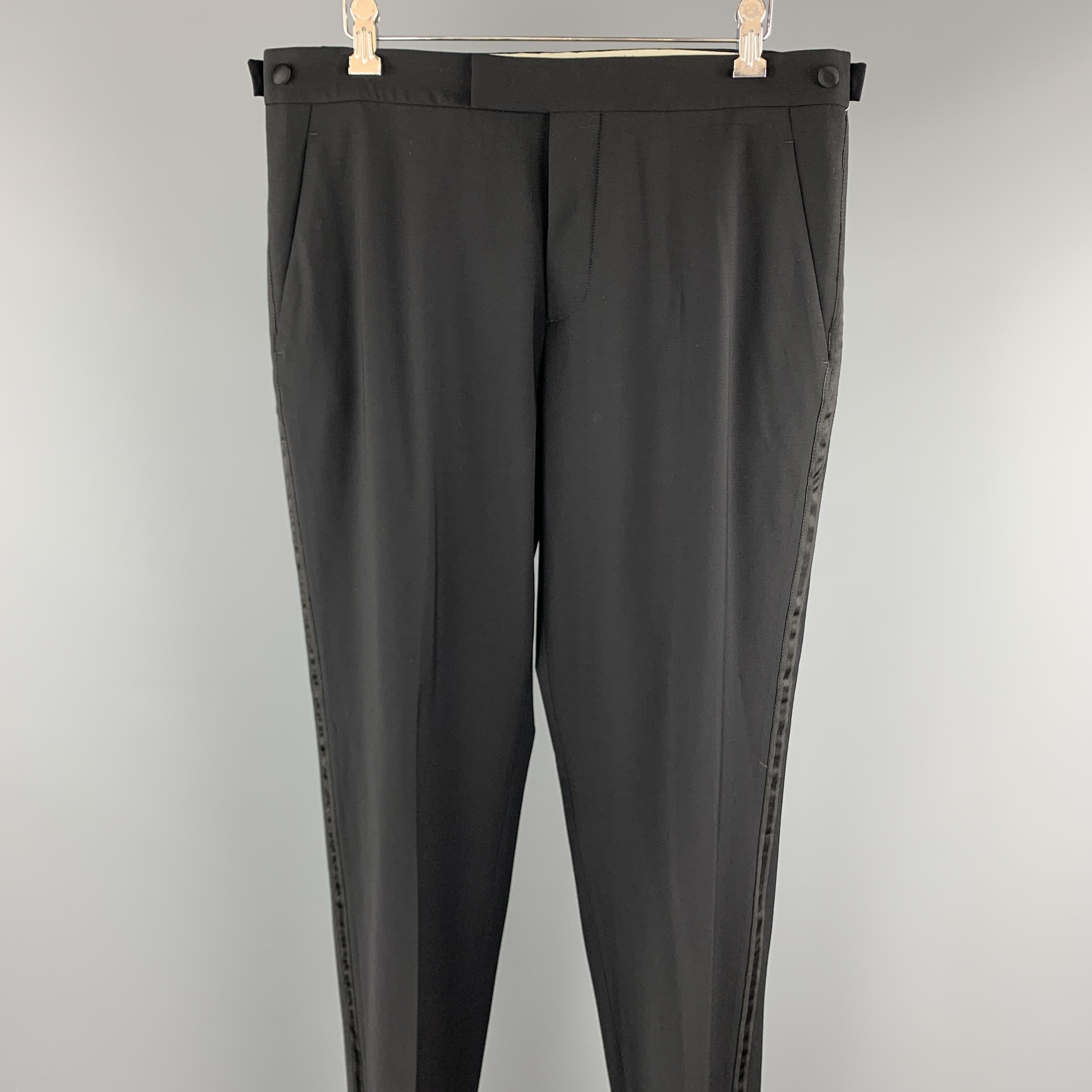 VINTAGE HELMUT LANG dress pants comes in a black wool featuring a tuxedo style, front tab, and a button fly closure. Made in Italy.

Excellent Pre-Owned Condition.
Marked: 48

Measurements:

Waist: 32 in. 
Rise: 9.5 in. 
Inseam: 32.5 in. 