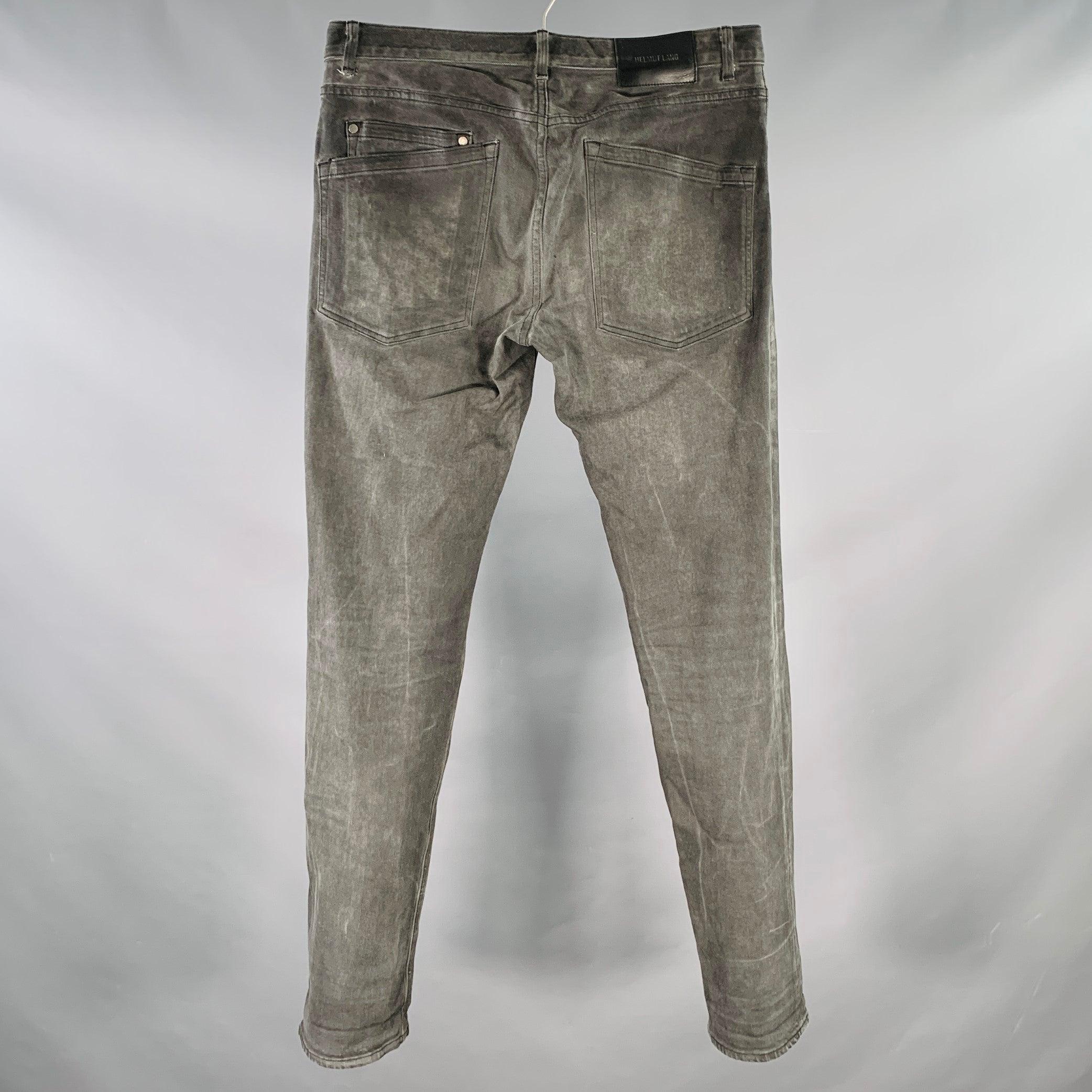 HELMUT LANG jeans
in a charcoal grey cotton blend denim featuring a slim fit, straight leg, and zip fly closure. Made in USA.Very Good Pre-Owned Condition. Minor marks. 

Marked:   32 

Measurements: 
  Waist: 32 inches Rise: 8.5 inches Inseam: 32