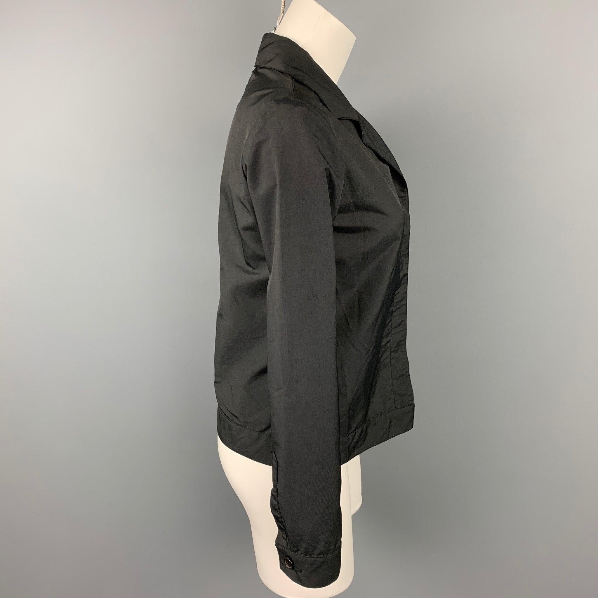 HELMUT LANG jacket comes in a black polyester featuring a notch lapel, front pocket, and a hidden button closure. Made in Italy.Very Good Pre-Owned Condition. 

Marked:   40 

Measurements: 
 
Shoulder: 15 inches Bust: 36 inches  Sleeve: 24 inches 