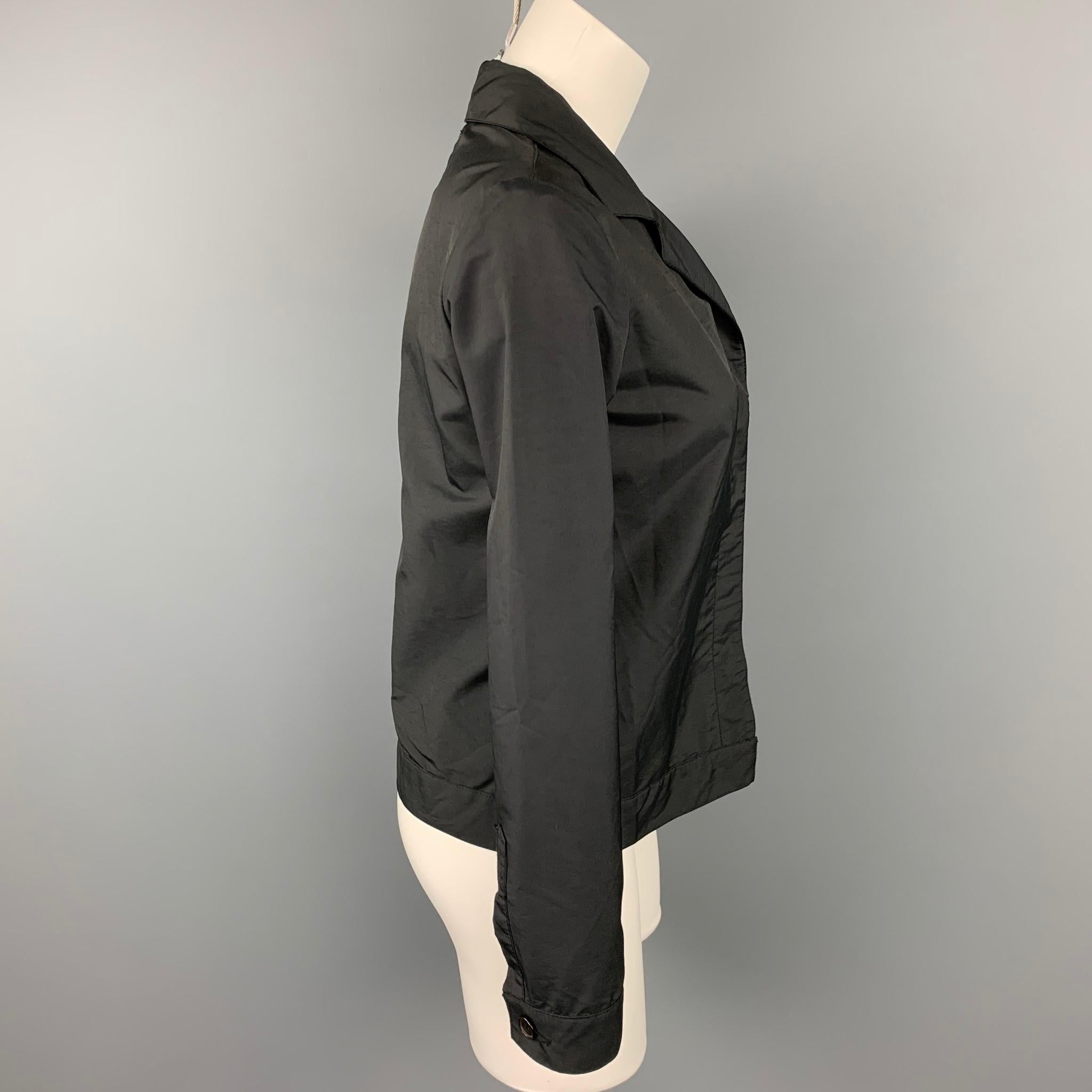 HELMUT LANG jacket comes in a black polyester featuring a notch lapel, front pocket, and a hidden button closure. Made in Italy.

Very Good Pre-Owned Condition.
Marked: 40

Measurements:

Shoulder: 15 in.
Bust: 36 in.
Sleeve: 24 in.
Length: 21.5 in.