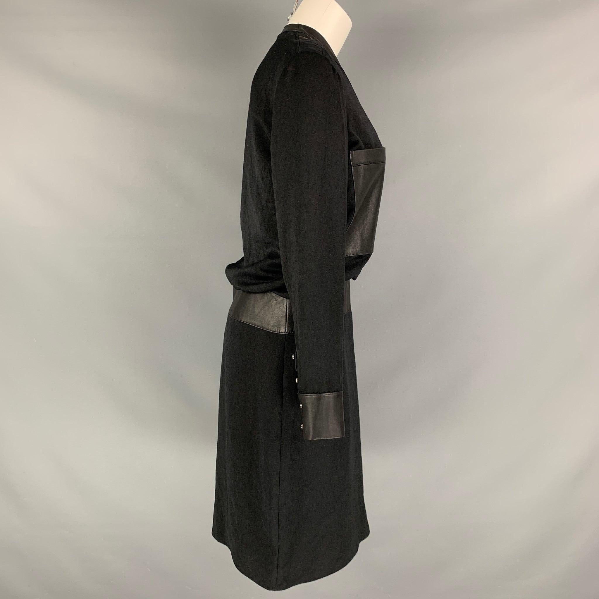 HELMUT LANG long sleeve dress comes in a black polyester woven material featuring a black leather lamb skin details, patch pockets, button down closure, and cuff sleeves. Made in USA.Excellent Pre-Owned Condition. Minor signs of wear. 

Marked:  6