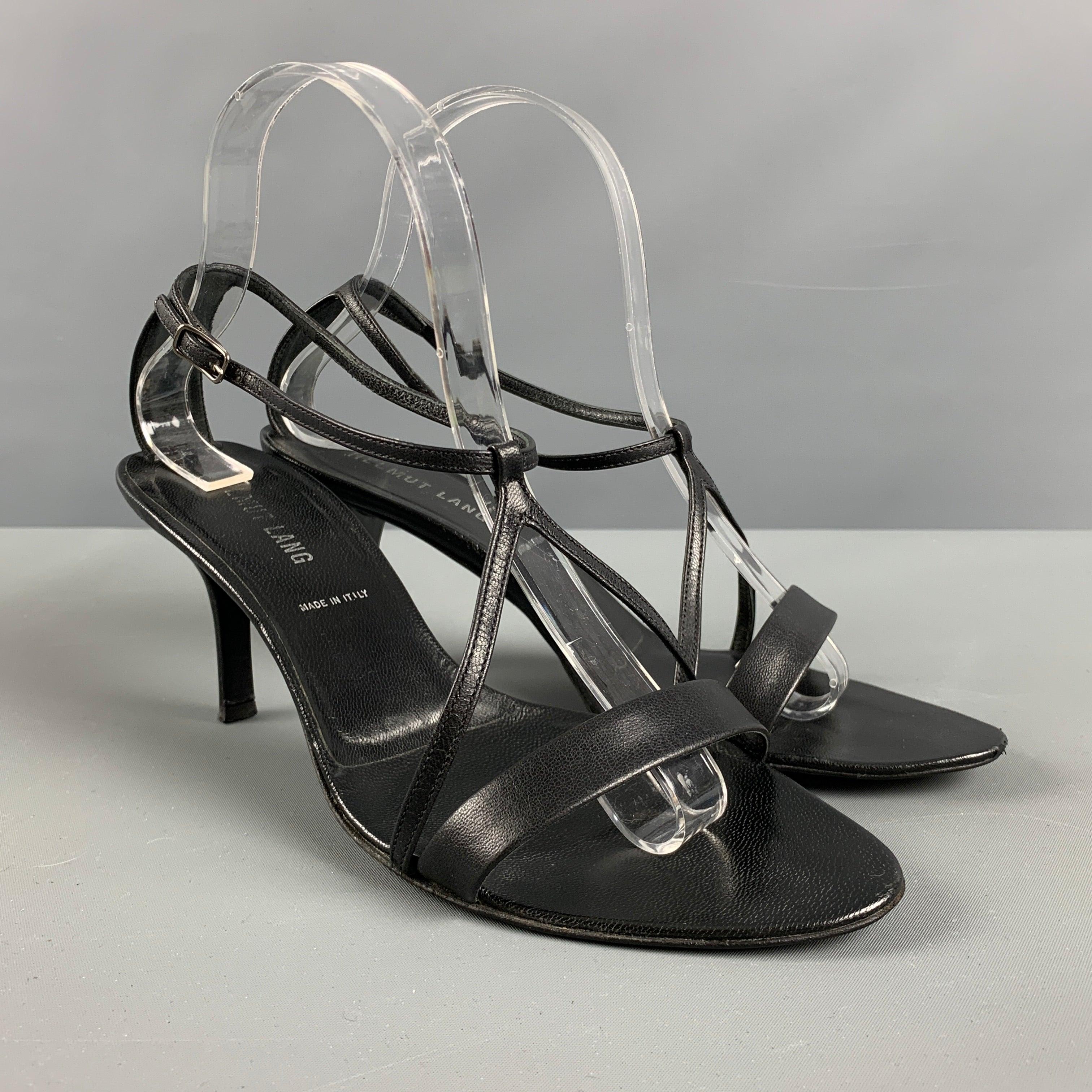 HELMUT LANG sandals comes in a black leather featuring a V-ankle strap, and a stiletto heel. Made in Italy.Very Good Pre-Owned Condition. Minor signs of wear. 

Marked:   38 1/2 

Measurements: 
  Heel: 3.25 inches 
  
  
 
Reference No.: