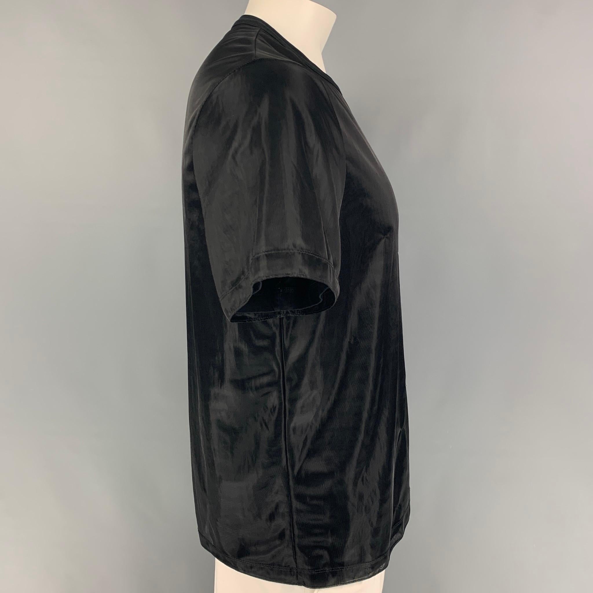 HELMUT LANG t-shirt comes in a black cotton / polyamide featuring a see through layer design and a crew-neck. Made in Portugal. 

Very Good Pre-Owned Condition.
Marked: L

Measurements:

Shoulder: 18 in.
Chest: 42 in.
Sleeve: 9.5 in.
Length: 27.5