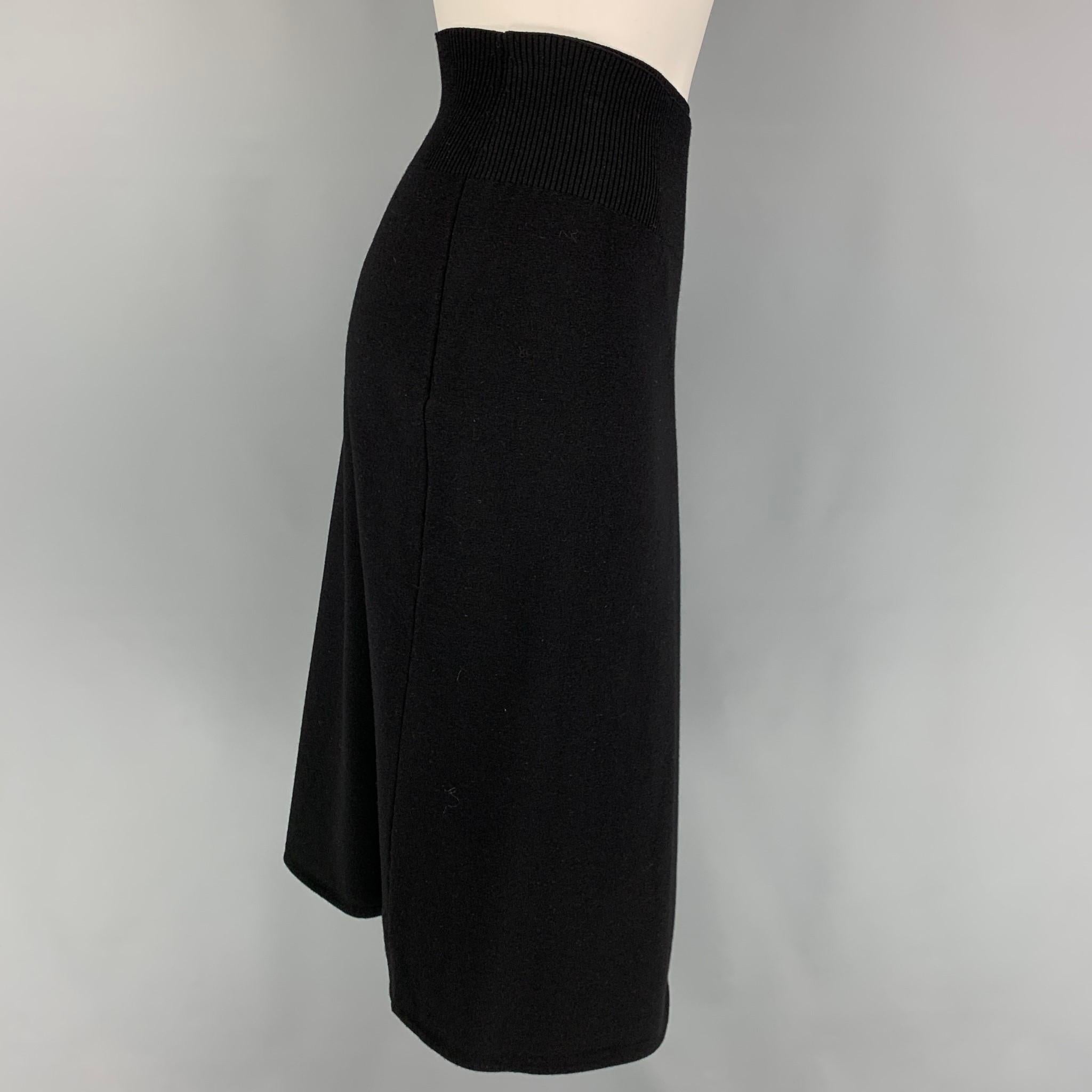 HELMUT LANG skirt comes in a black wool featuring a self tie belt detail, elastic waistband, and a open front. 

New With Tags. 
Marked: L
Original Retail Price: $495.00

Measurements:

Waist: 30 in.
Hip: 38 in.
Length: 26 in. 